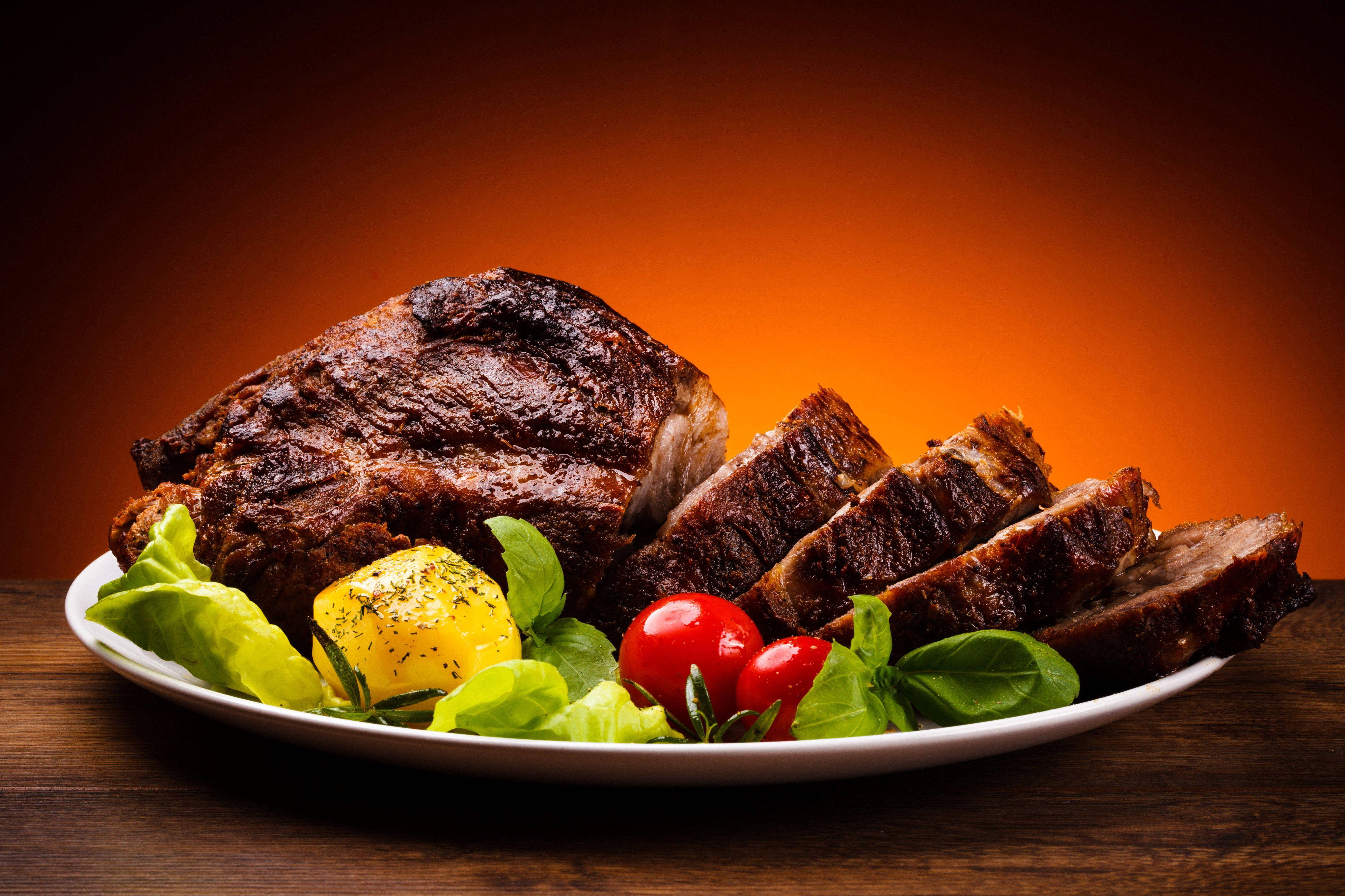 Food Photography 桌布 壁紙 — 多汁烤牛肉切片和新鮮蔬菜放在白色盤子上，背景是溫暖的橙色漸變。