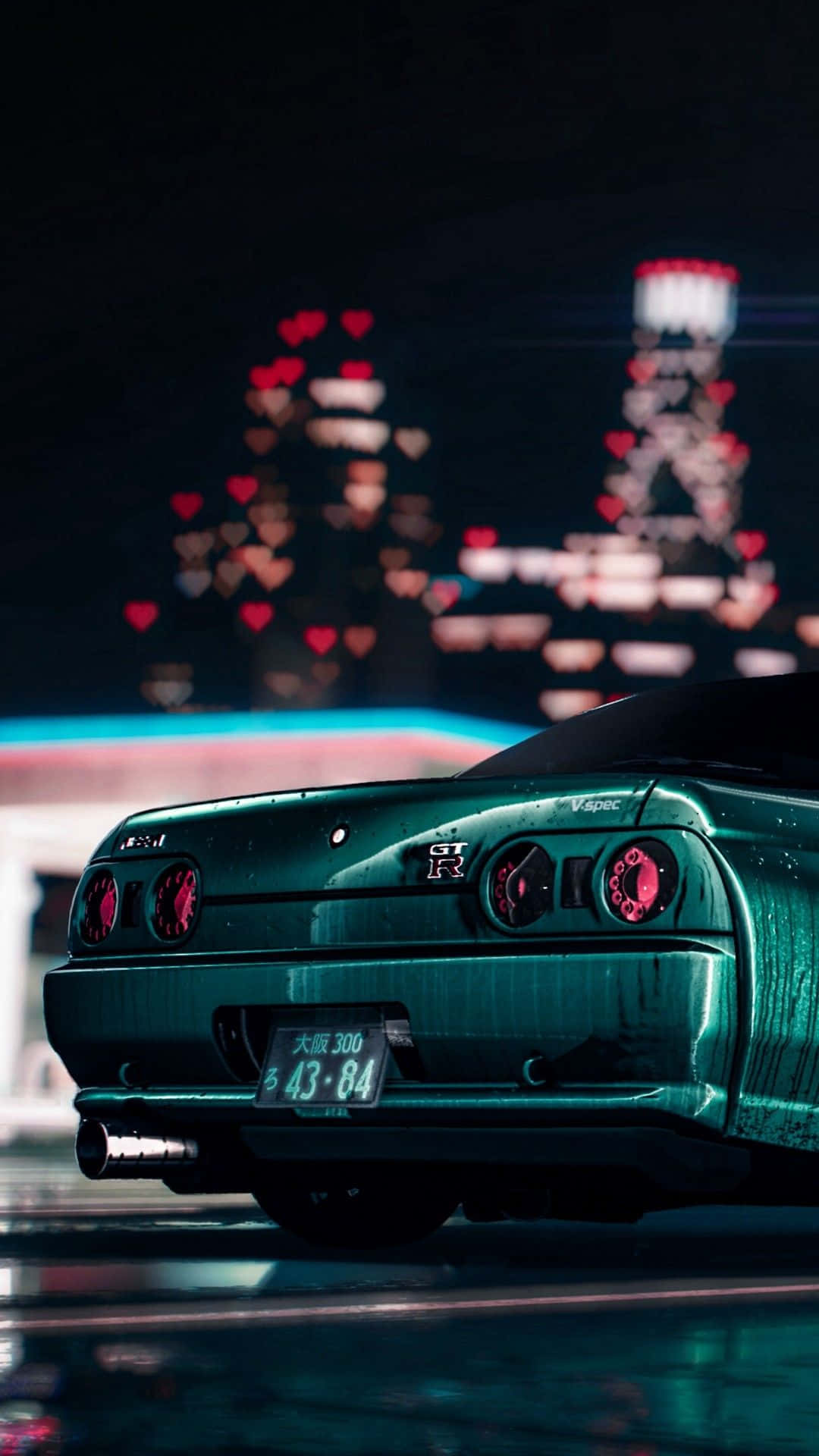 JDM iPhone 桌布 壁紙 — 夜晚中一輛青綠色的日產GT-R，帶有發光的紅色尾燈和背後模糊的心形燈光城市景觀。