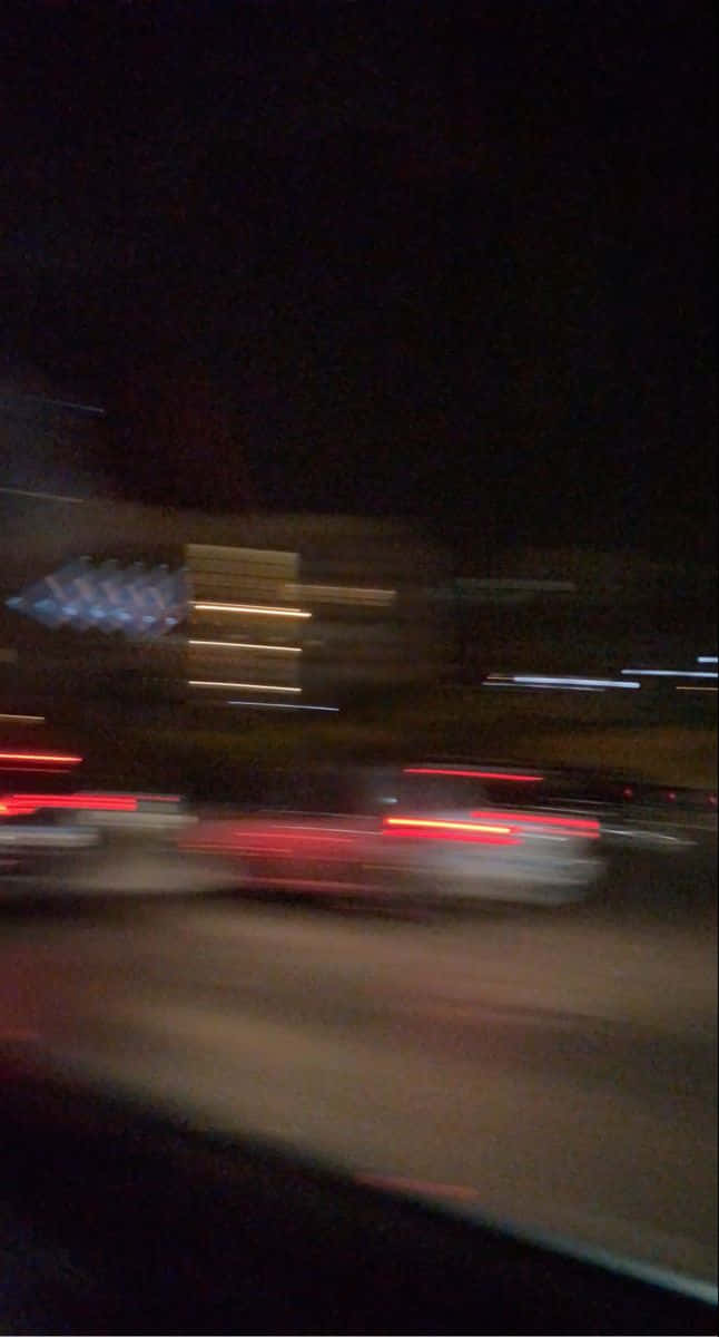 Road 桌布 壁紙 — 夜間動態模糊捕捉到紅色和白色車燈在黑暗的城市街道上飛馳而過的光跡。