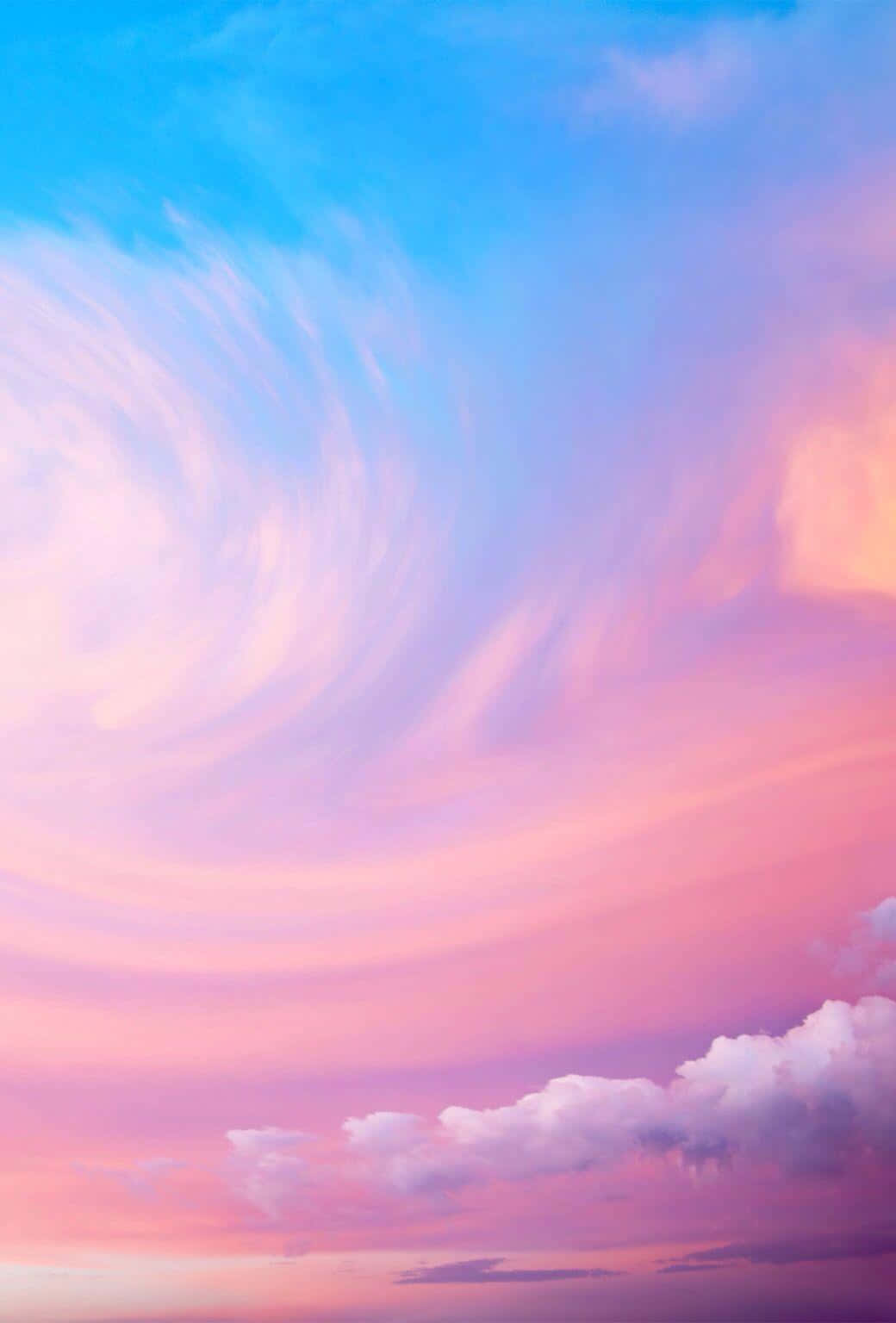 Pink Sky 桌布 壁紙 — 夢幻般的天空在日落時分旋轉著柔和的粉彩雲，從藍綠色過渡到粉紅色和蜜桃色。