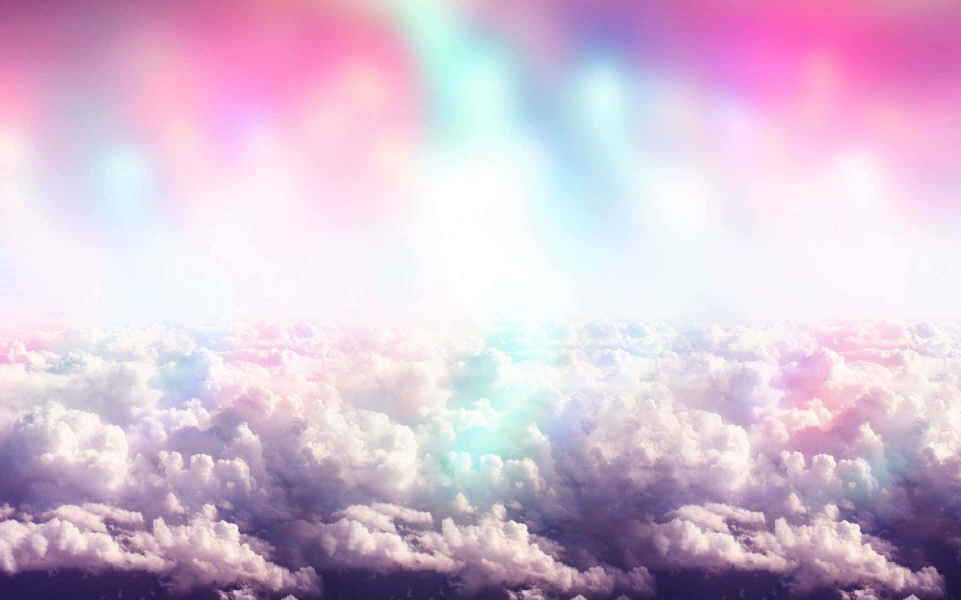 Cute Rainbow 桌布 壁紙 — 夢幻般的空中視角，蓬鬆的雲朵沐浴在柔和的粉紅、藍色和紫色光線中。