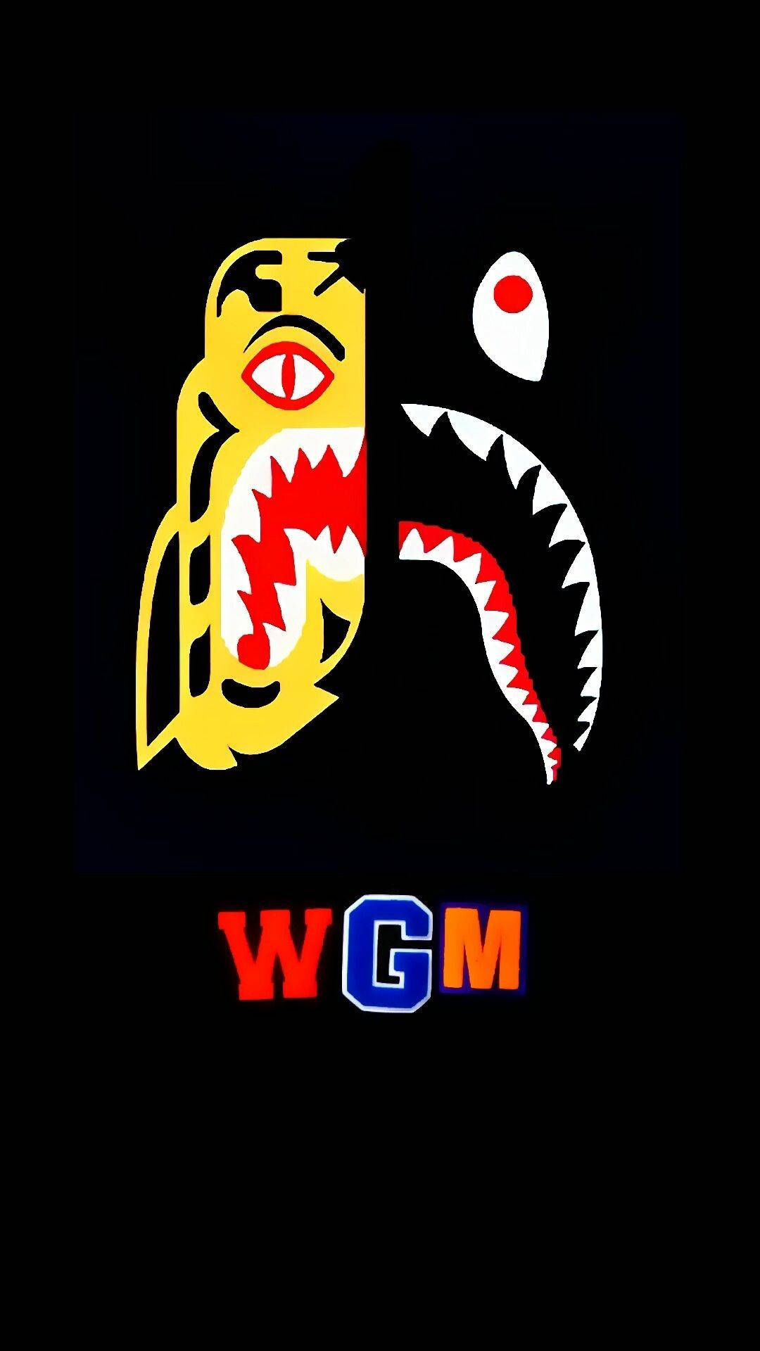 bape logo 桌布 壁紙 — 大膽圖形：黃色鯊魚，紅色嘴巴，白色牙齒，黑色背景，彩色WGM文字。