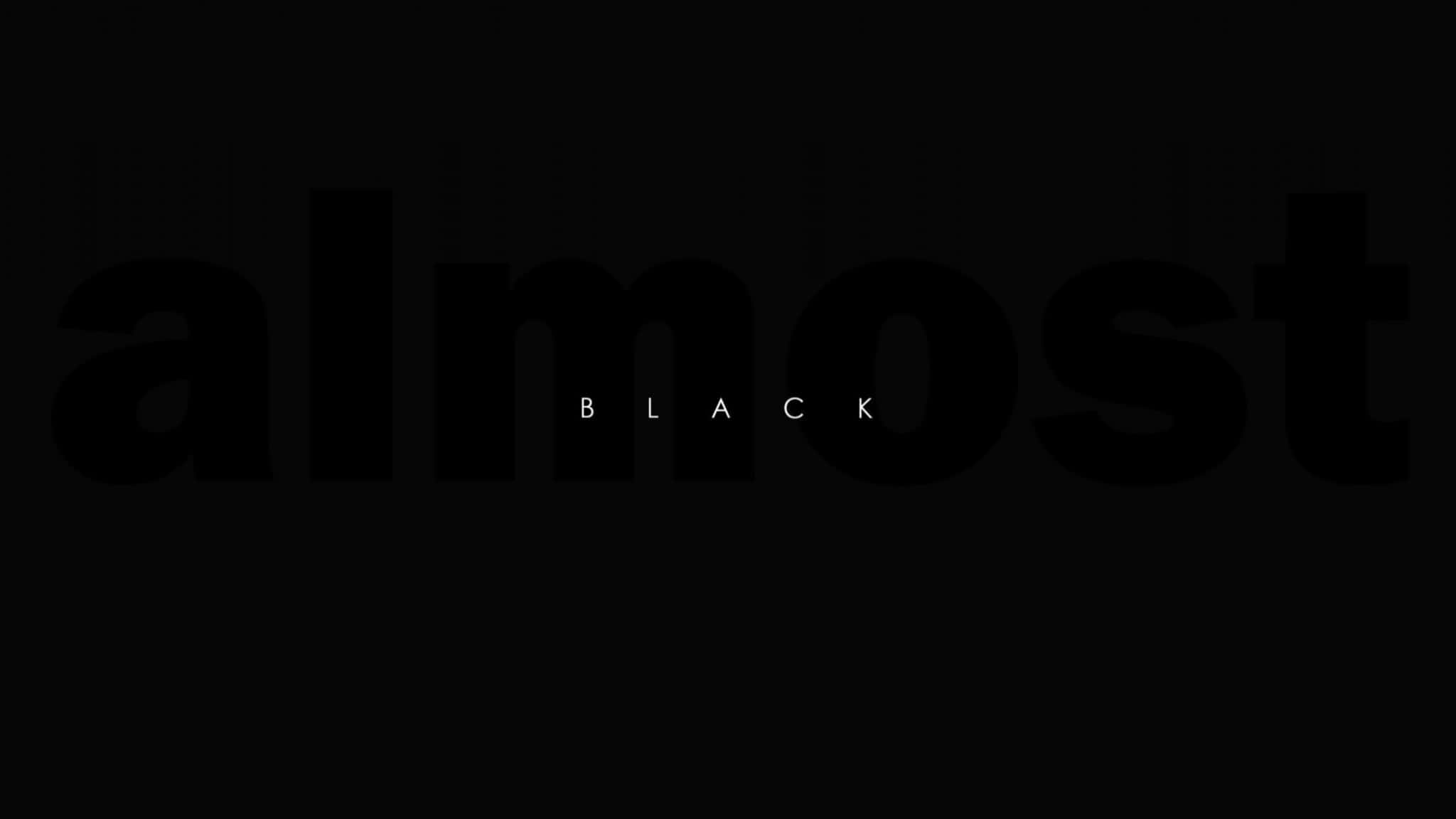 2048x1152 Aesthetic 桌布 壁紙 — 大膽極簡字體設計，以大型黑色字母拼出「almost」，下方中央以小型白色字母顯示「BLACK」，背景為純黑色。