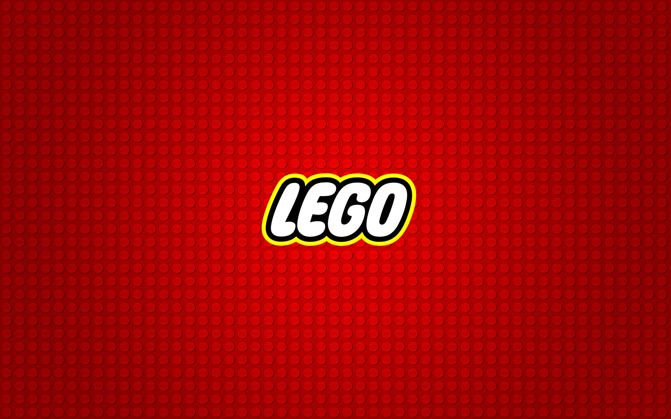 Brand 桌布 壁紙 — 大膽的LEGO標誌，以白色、黃色和黑色為中心，置於充滿活力的紅色磚紋背景上。
