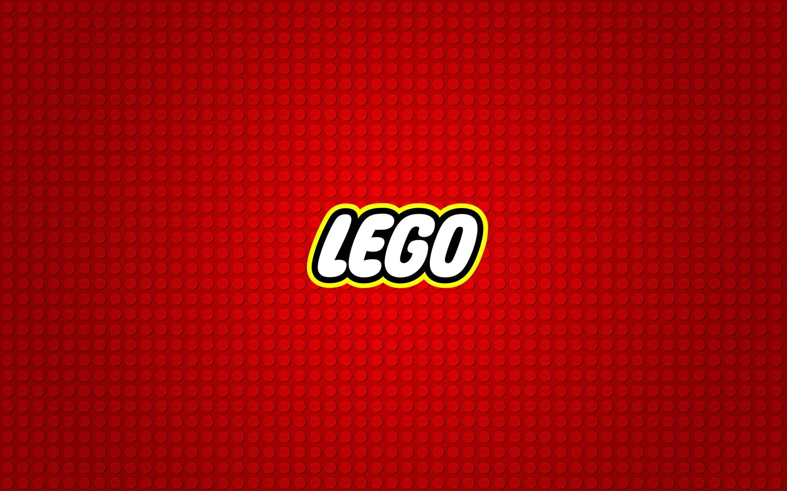 紅色動圖 桌布 壁紙 — 大膽的LEGO標誌以白色和黃色居中於紋理紅磚背景上。