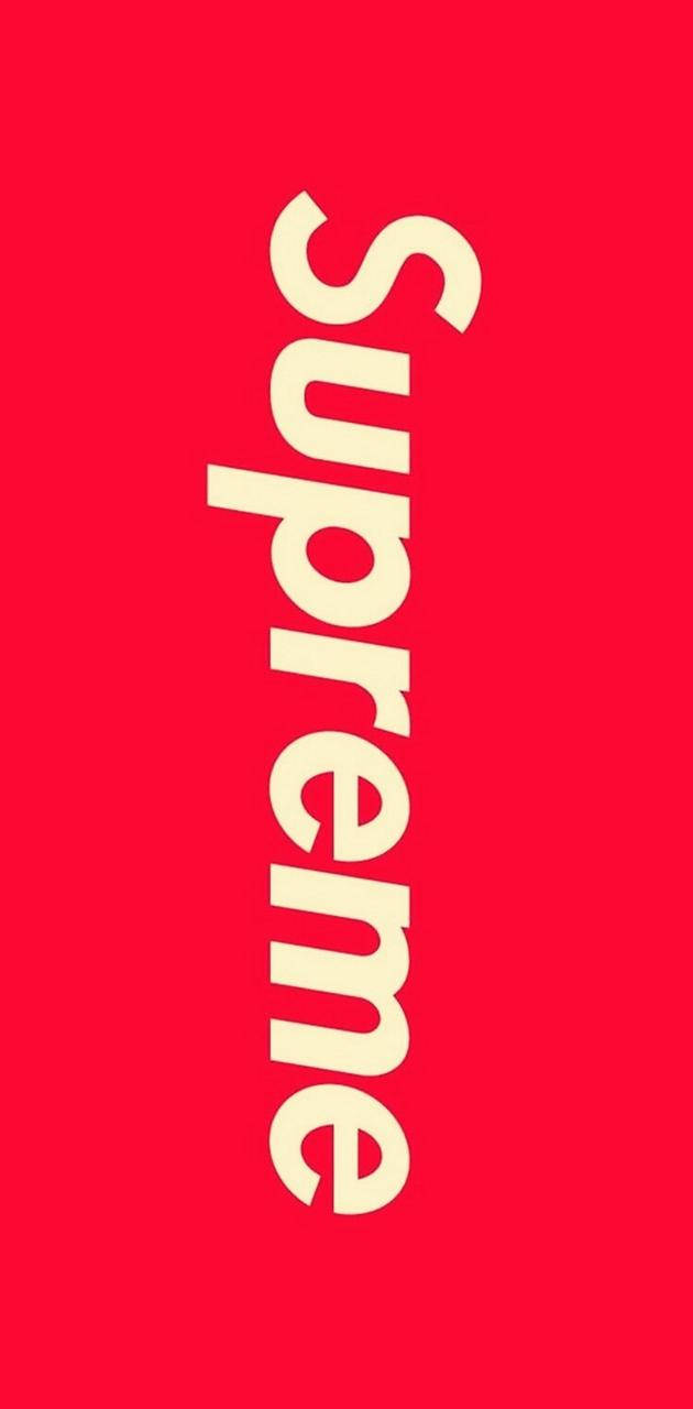 supreme aesthetic 桌布 壁紙 — 大膽的奶油色 'Supreme' 標誌垂直居中在純紅色背景上。