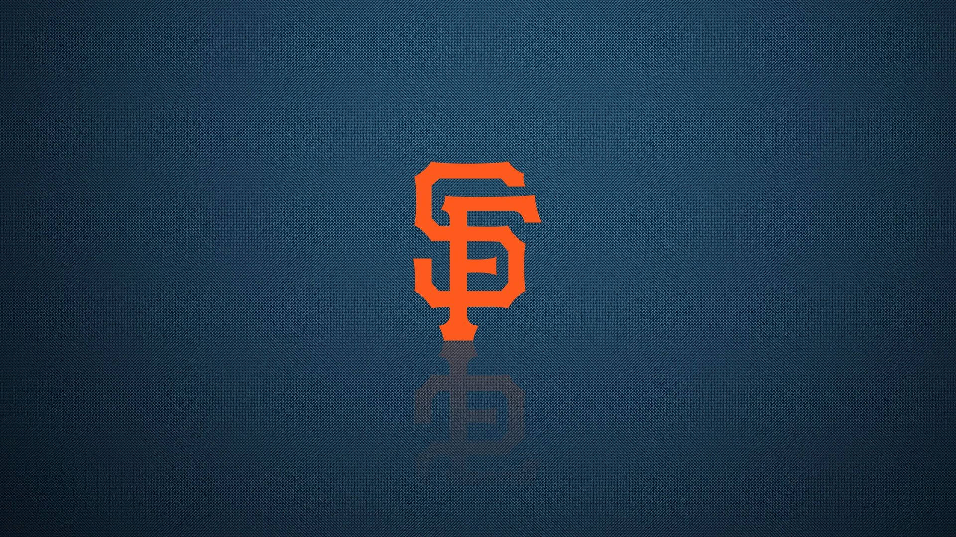 Giants 桌布 壁紙 — 大膽的橙色SF標誌居中於帶紋理的藍色背景上，下方有微妙的倒影。