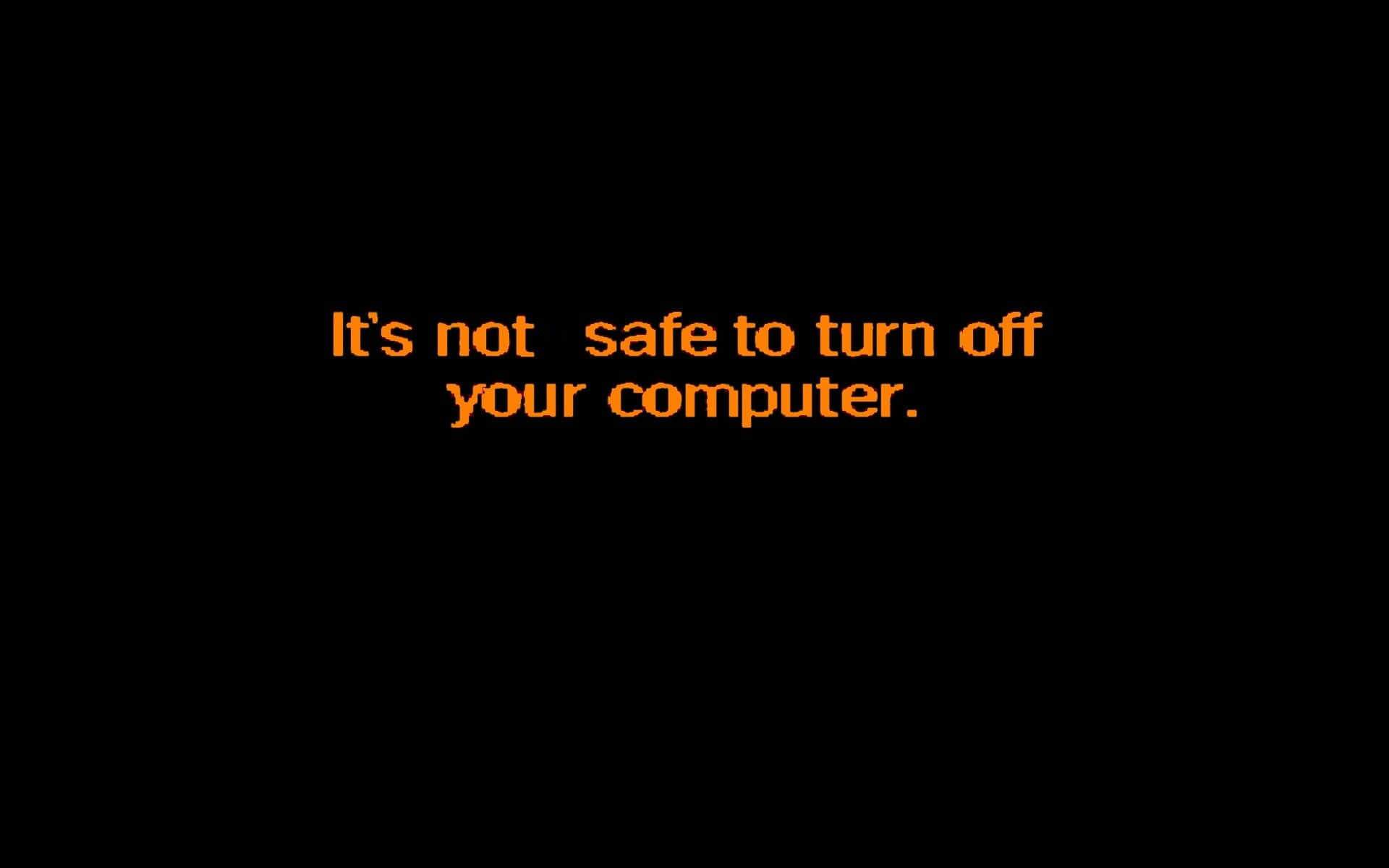 Windows 98 桌布 壁紙 — 大膽的橙色像素文字在純黑色背景上警告「關閉電腦並不安全」。