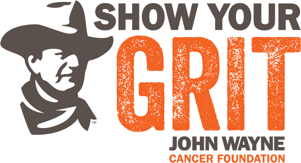 wayne 桌布 壁紙 — 大膽的橙色粗糙文字寫著「SHOW YOUR GRIT」，旁邊是約翰韋恩癌症基金會的灰色牛仔剪影標誌。