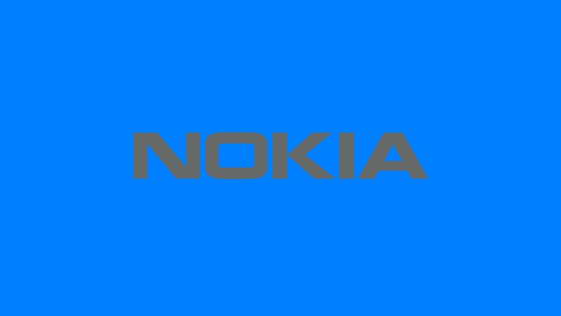 諾基亞 桌布 壁紙 — 大膽的灰色 Nokia 標誌居中放置在純色鮮豔藍色背景上。