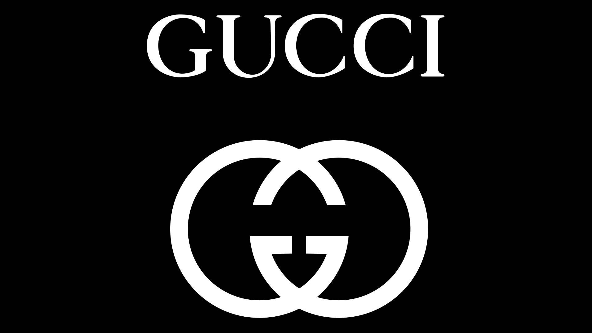 Gucci 品牌標誌和互鎖 G 徽章以白色顯示在黑色背景上。 — Gucci GIF 壁紙