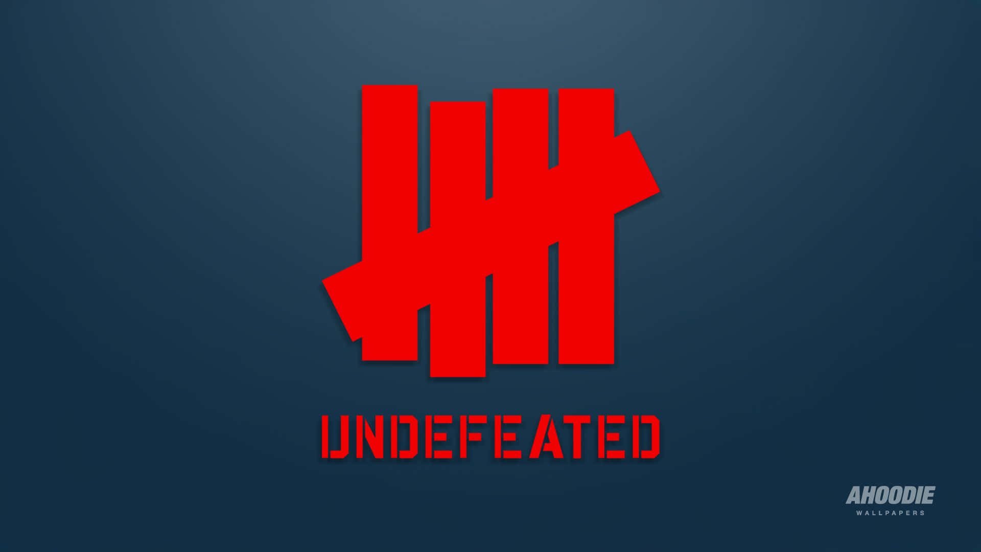 標誌 桌布 壁紙 — 大膽的紅色 Undefeated 標誌在帶有微妙燈光效果的漸變深藍色背景上脫穎而出。
