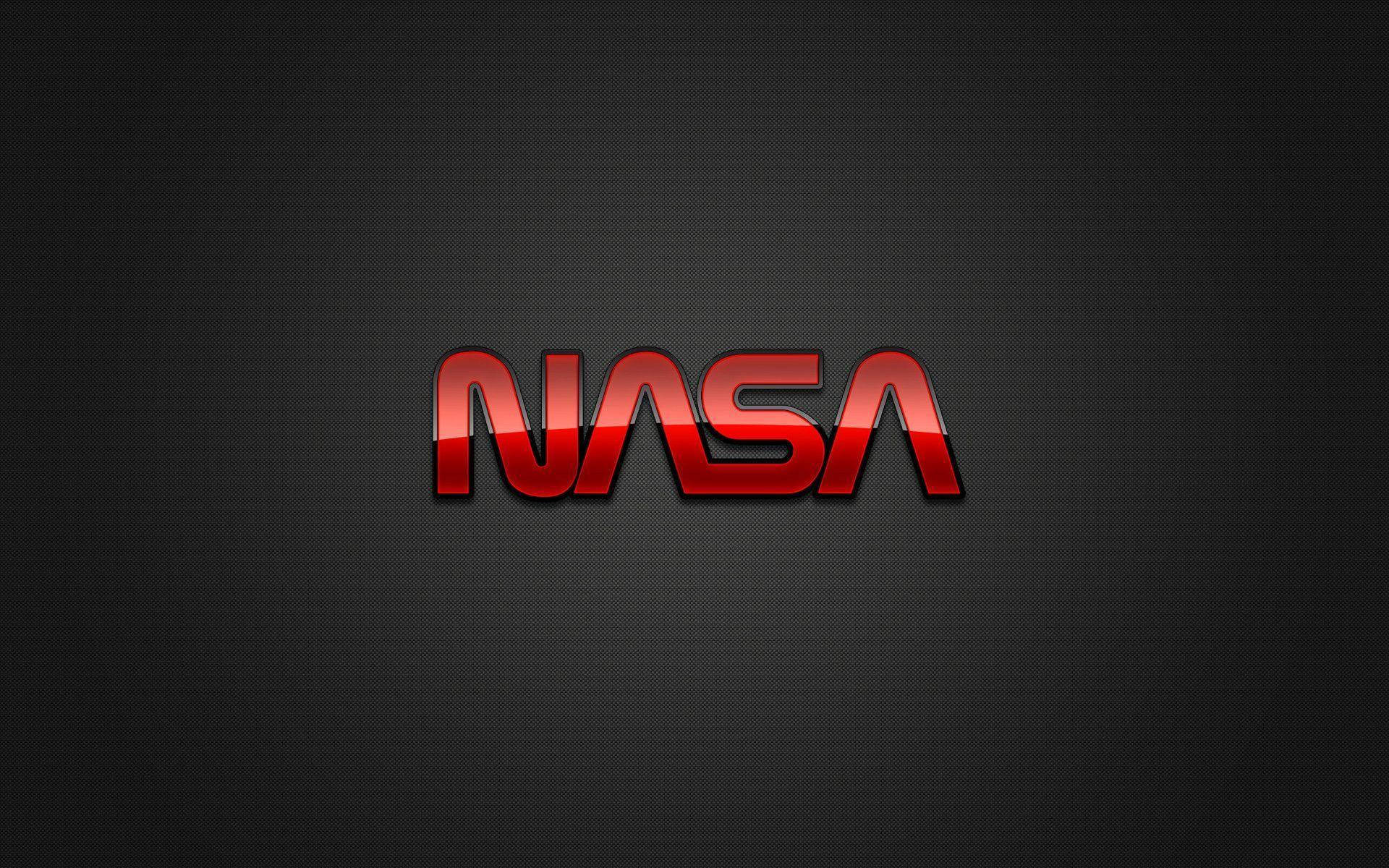 nasa 美學 桌布 壁紙 — 大膽的紅色NASA標誌，帶有金屬光澤，居中於深色紋理背景上。