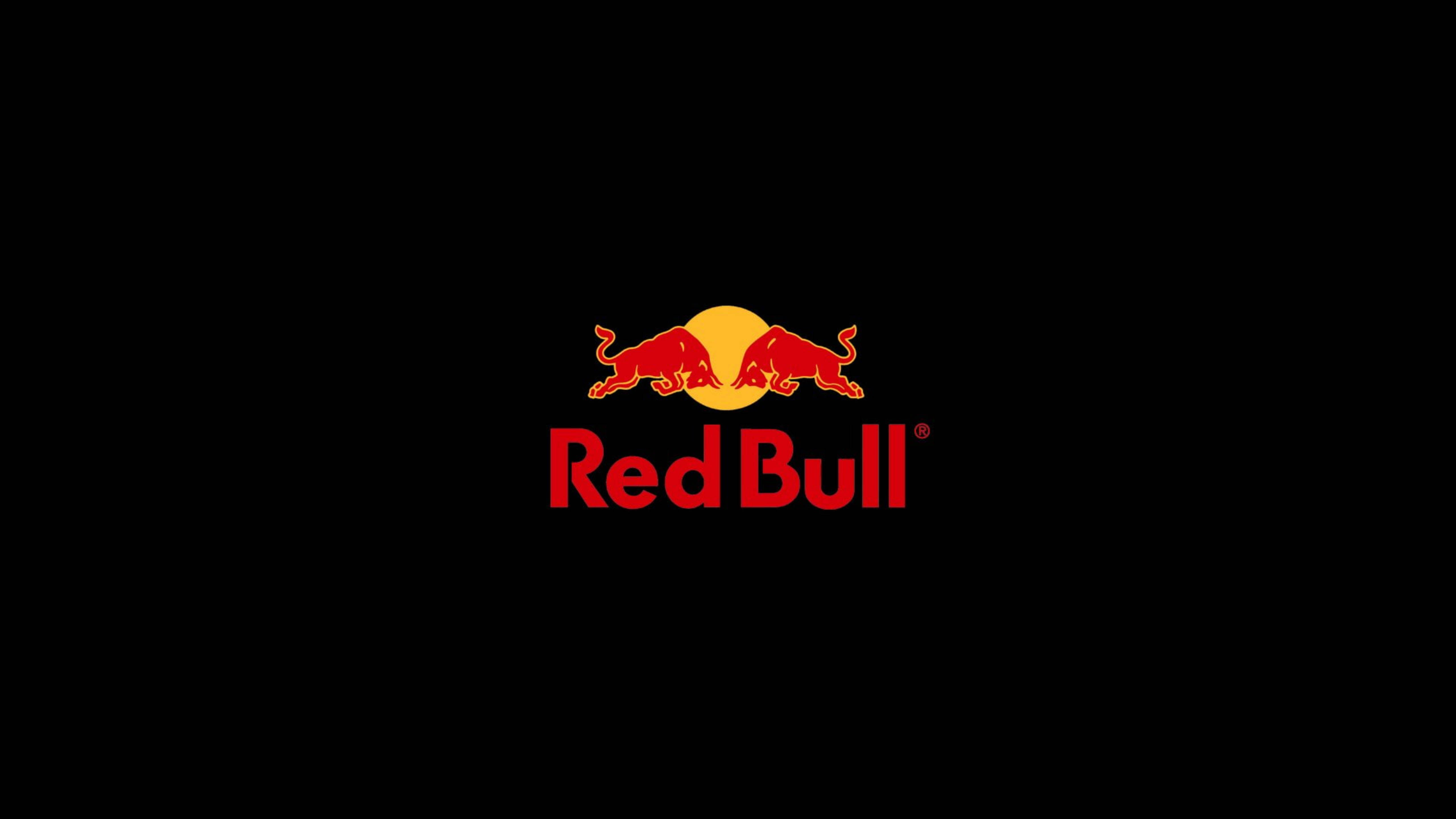 bull 桌布 壁紙 — 大膽的紅色公牛衝向黑色背景上的黃色太陽，下方有「Red Bull」文字。