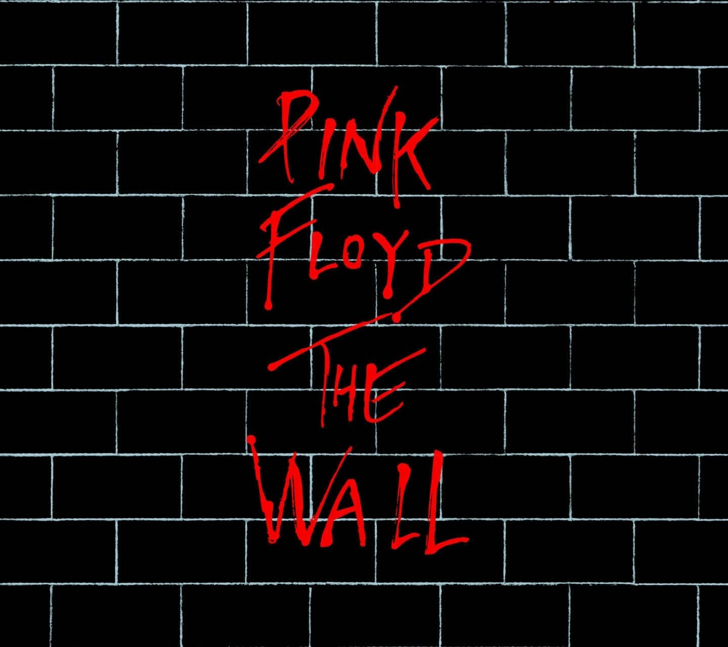 Floyd 桌布 壁紙 — 大膽的紅色塗鴉風格文字在黑色磚牆上拼出 PINK FLOYD THE WALL。