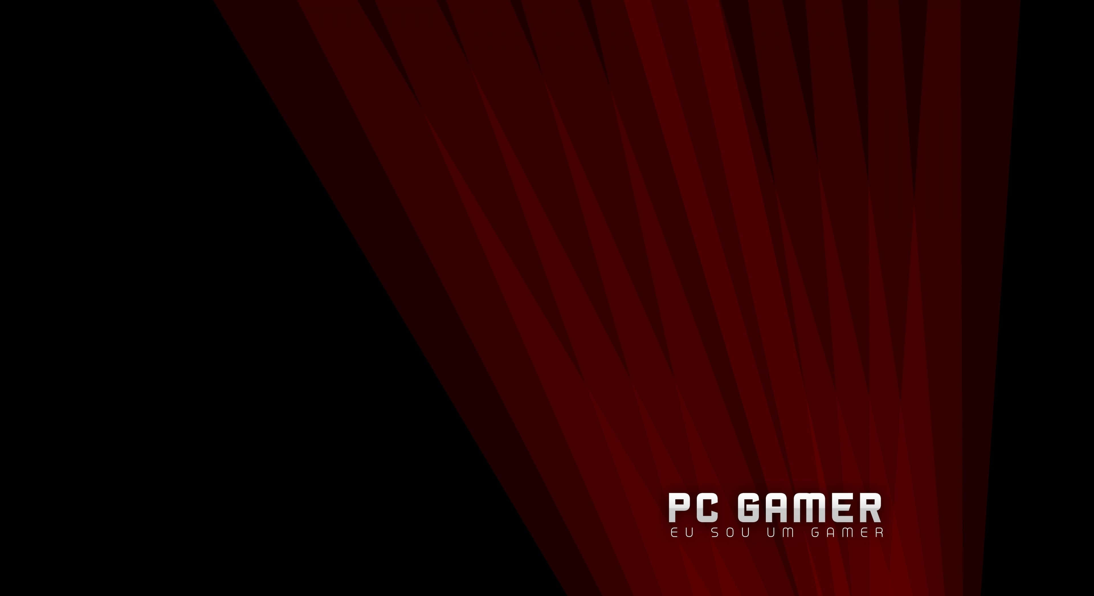 Gaming Pc 桌布 壁紙 — 大膽的紅色幾何射線在黑色背景上對角線放射，右下角有白色遊戲文字。