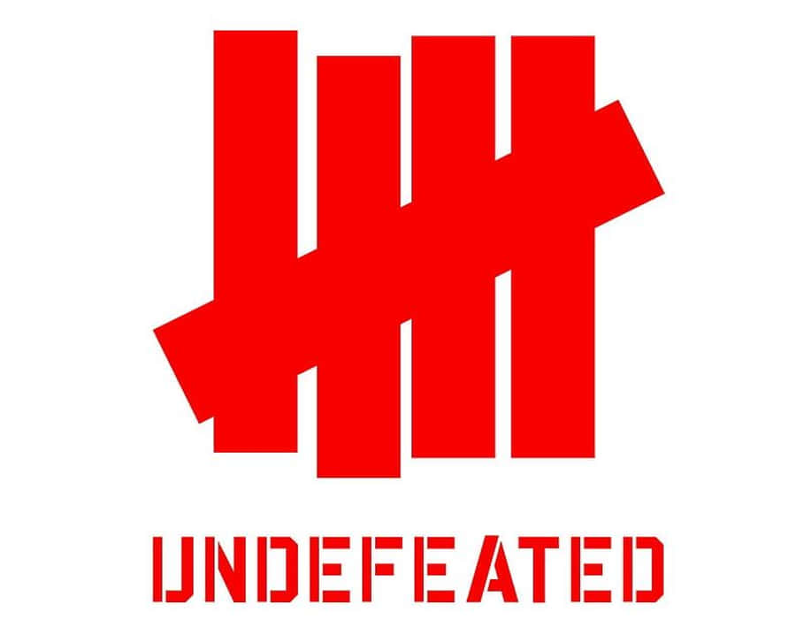 Sneakerhead 桌布 壁紙 — 大膽的紅色風格化標誌，下方有「UNDEFEATED」文字，白色背景。