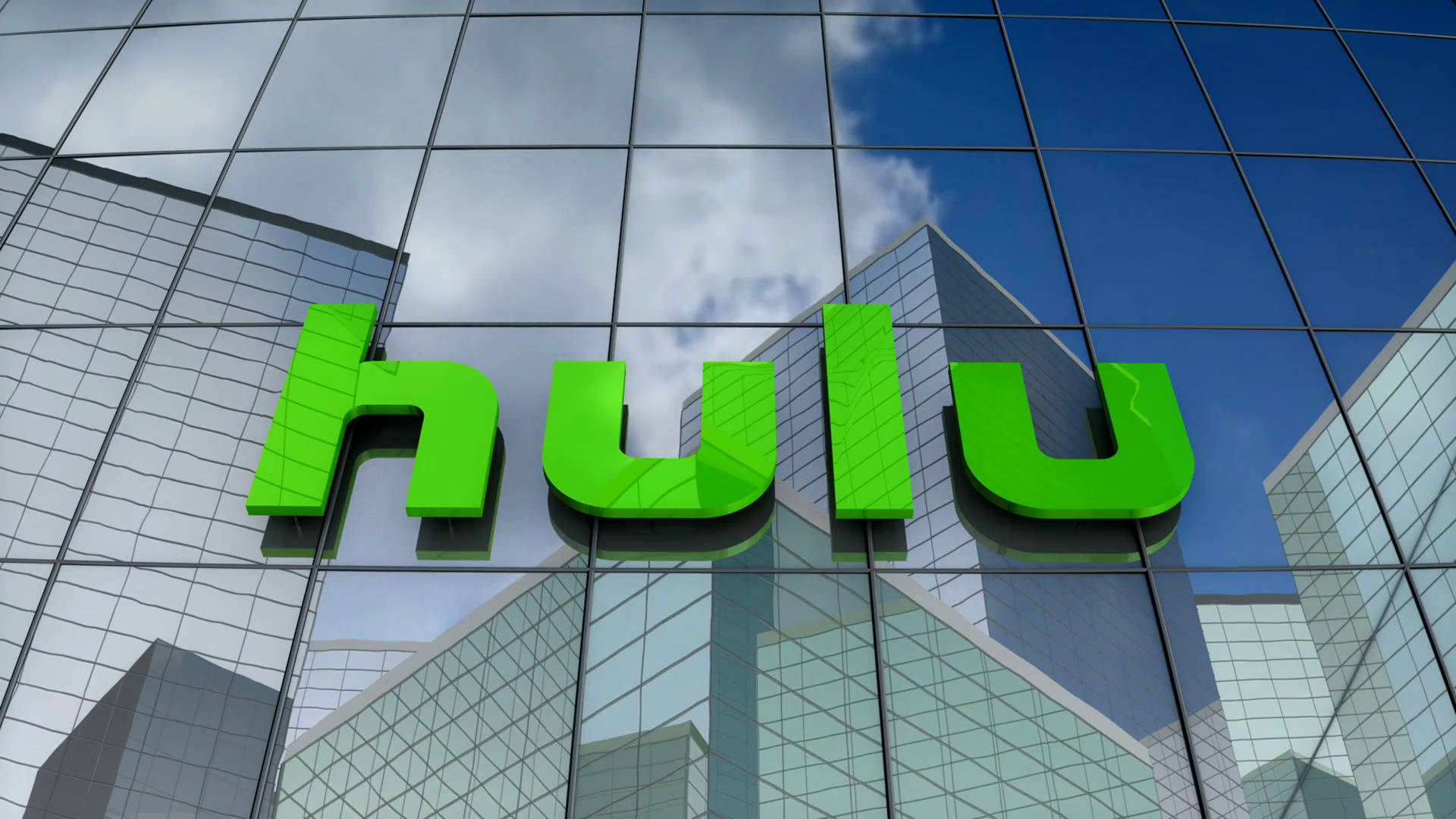 Hulu 桌布 壁紙 — 大膽的綠色Hulu標誌安裝在玻璃摩天大樓外牆上，反射藍天和白雲。
