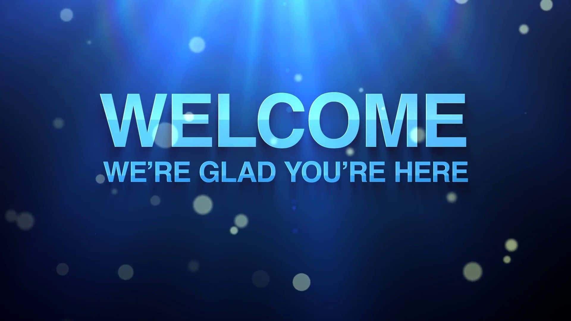 Welcome 桌布 壁紙 — 大膽的藍色歡迎文字在深藍色背景上發光，伴隨著光線和漂浮的散景粒子。