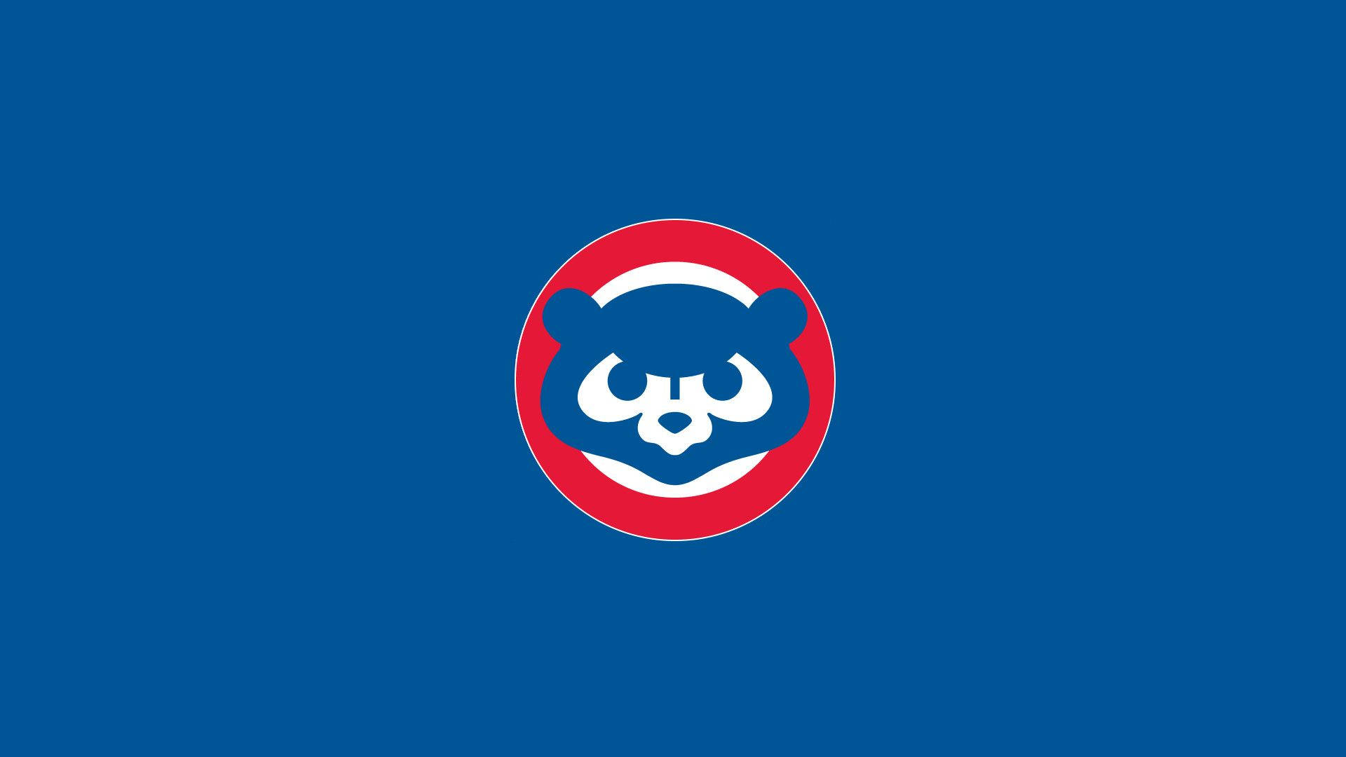 Cubs 桌布 壁紙 — 大膽的藍色背景上有一個紅色圓圈，中央是風格化的白色和藍色熊頭標誌。