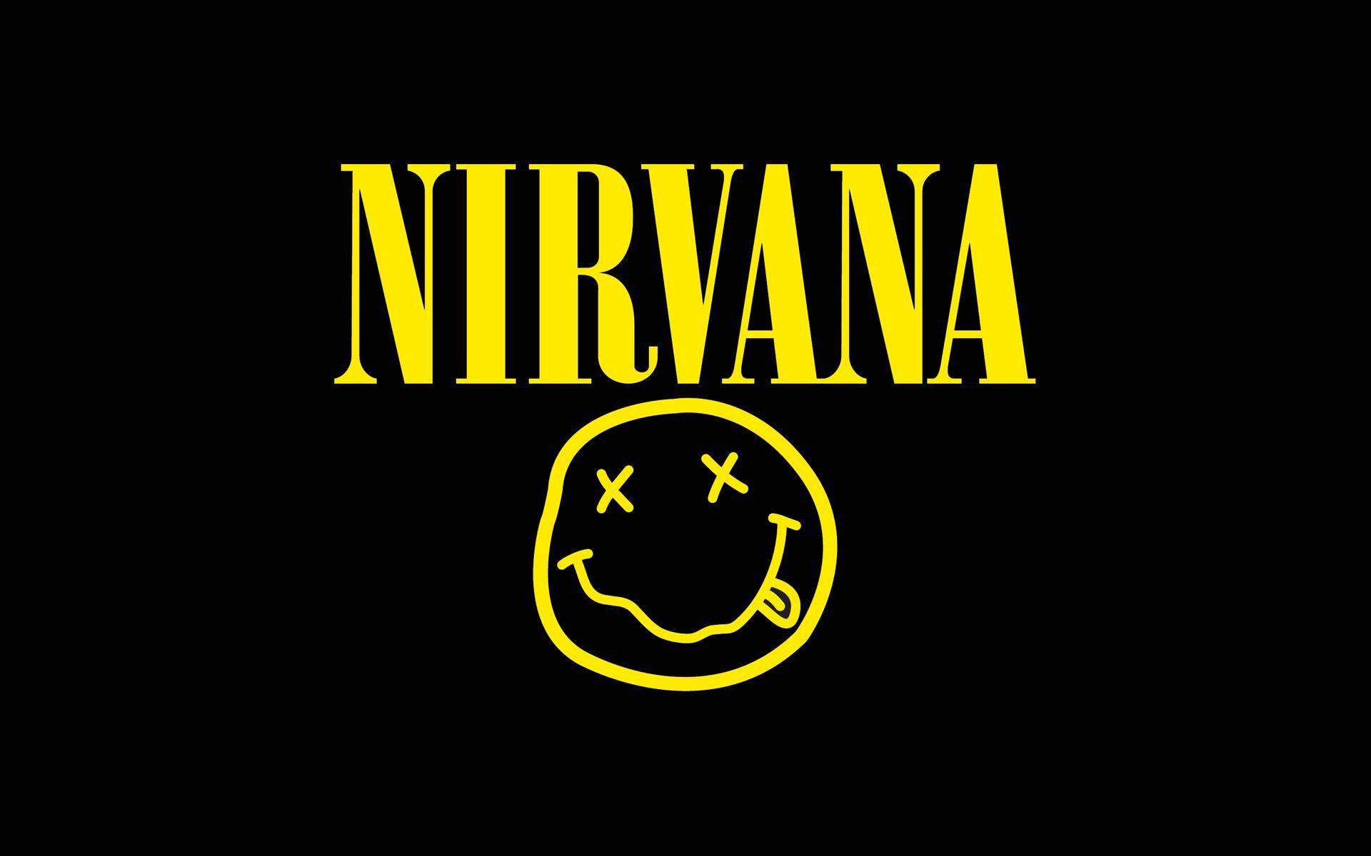 nirvana 4K 桌布 壁紙 — 大膽的黃色Nirvana標誌，帶有笑臉，襯托在強烈的黑色背景上。