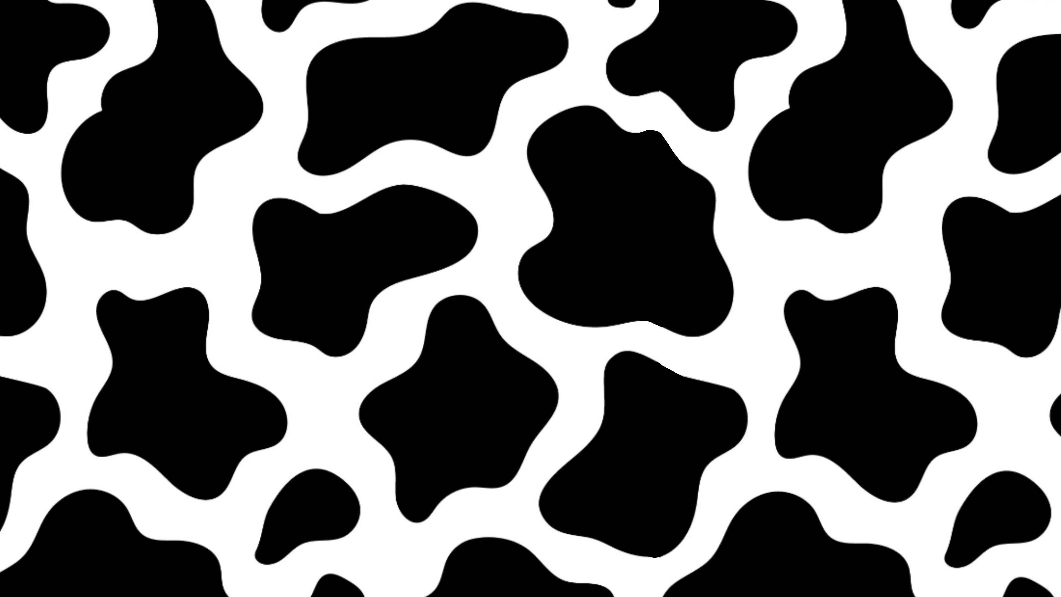 Cow Pattern 桌布 壁紙 — 大膽的黑白乳牛印花圖案，在乾淨背景上呈現不規則的有機形狀。