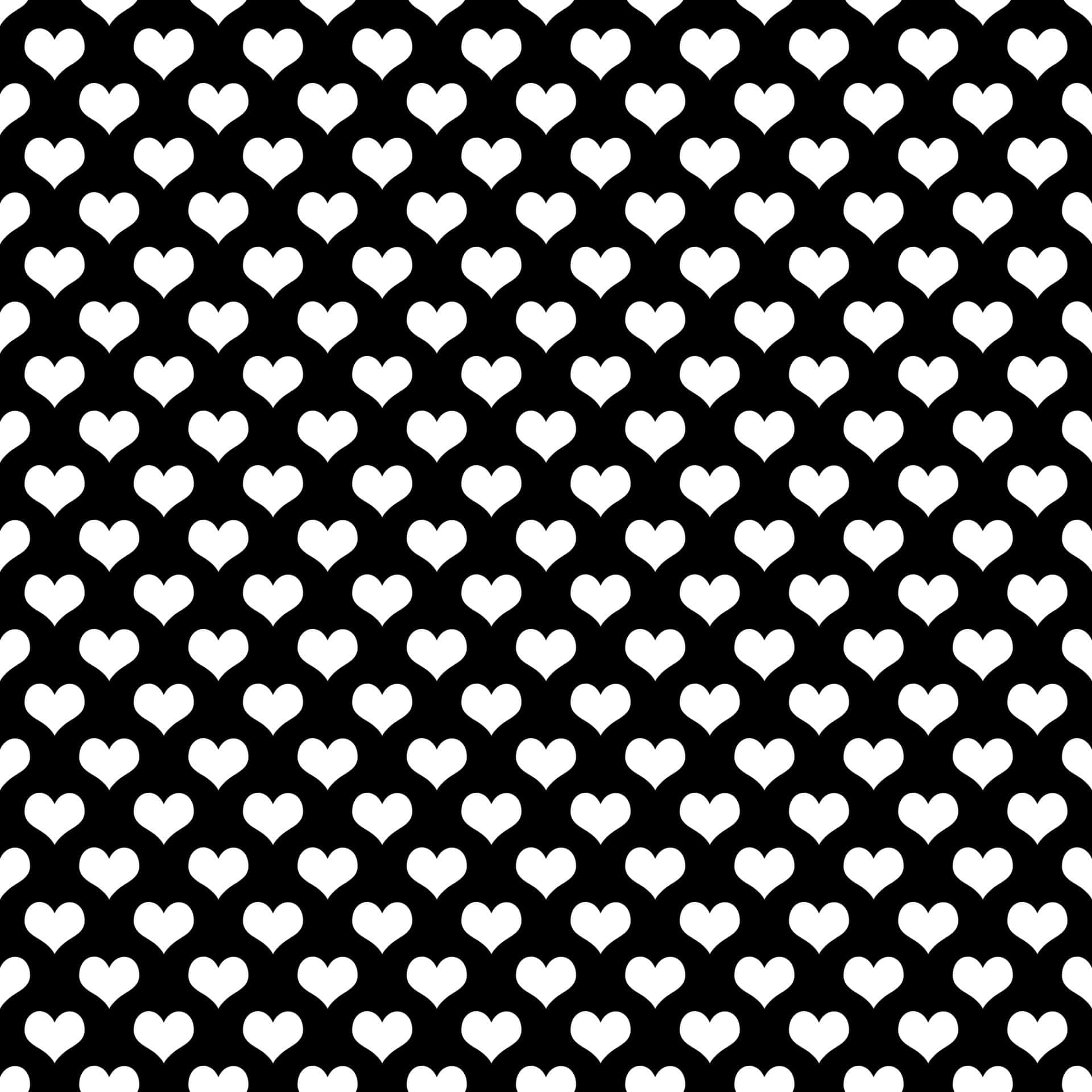 Black And White Heart 桌布 壁紙 — 大膽的黑白壁紙，黑色背景上重複排列白色心形圖案。