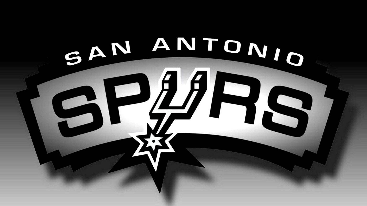 Spurs 桌布 壁紙 — 大膽的黑白聖安東尼奧馬刺隊標誌，星形徽章居中，背景為漸變色。