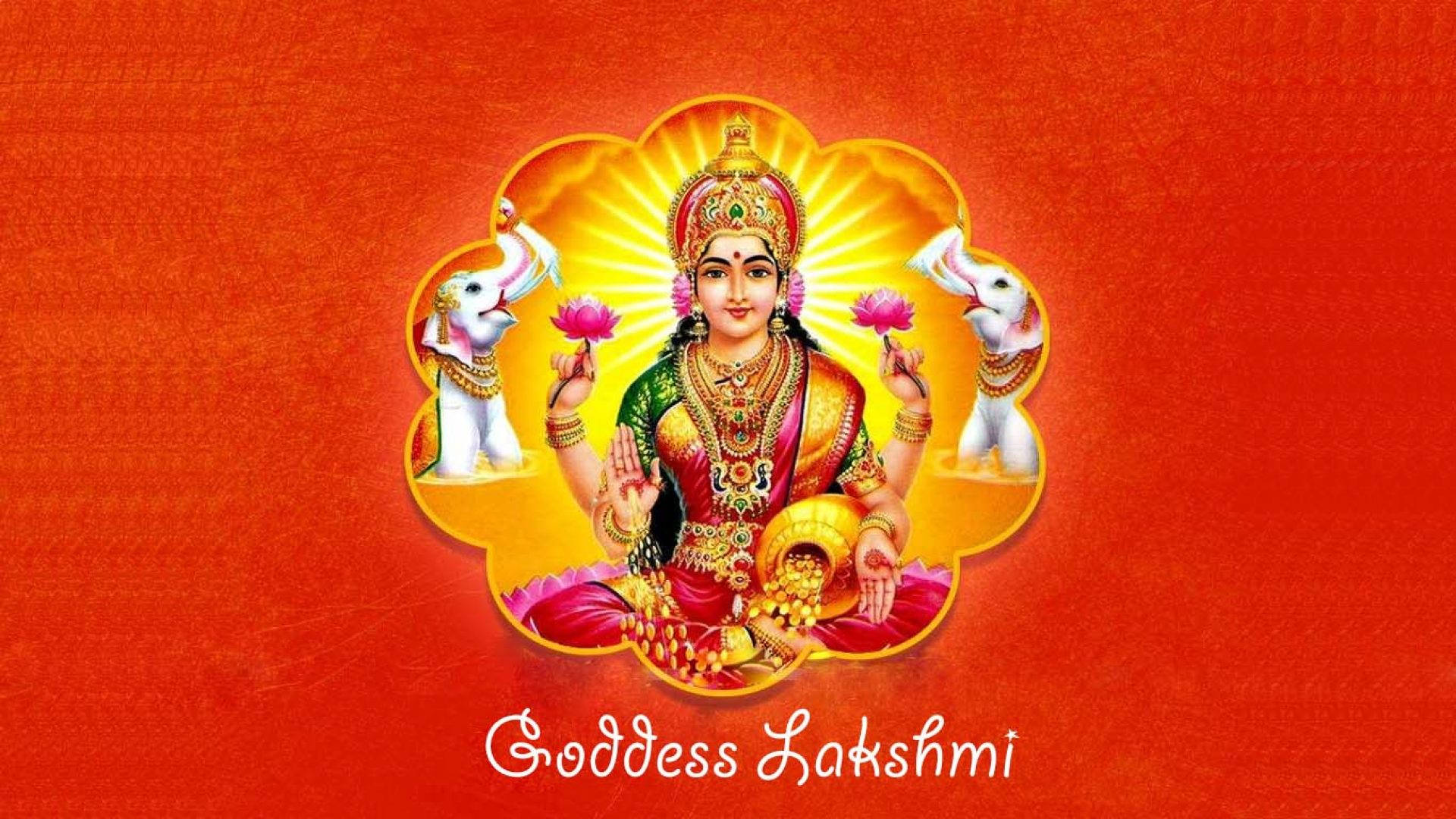Lakshmi Devi 桌布 壁紙 — 女神拉克什米以金色和紅色裝飾，光芒四射地坐著，大象手持蓮花，背景是發光的橙色。