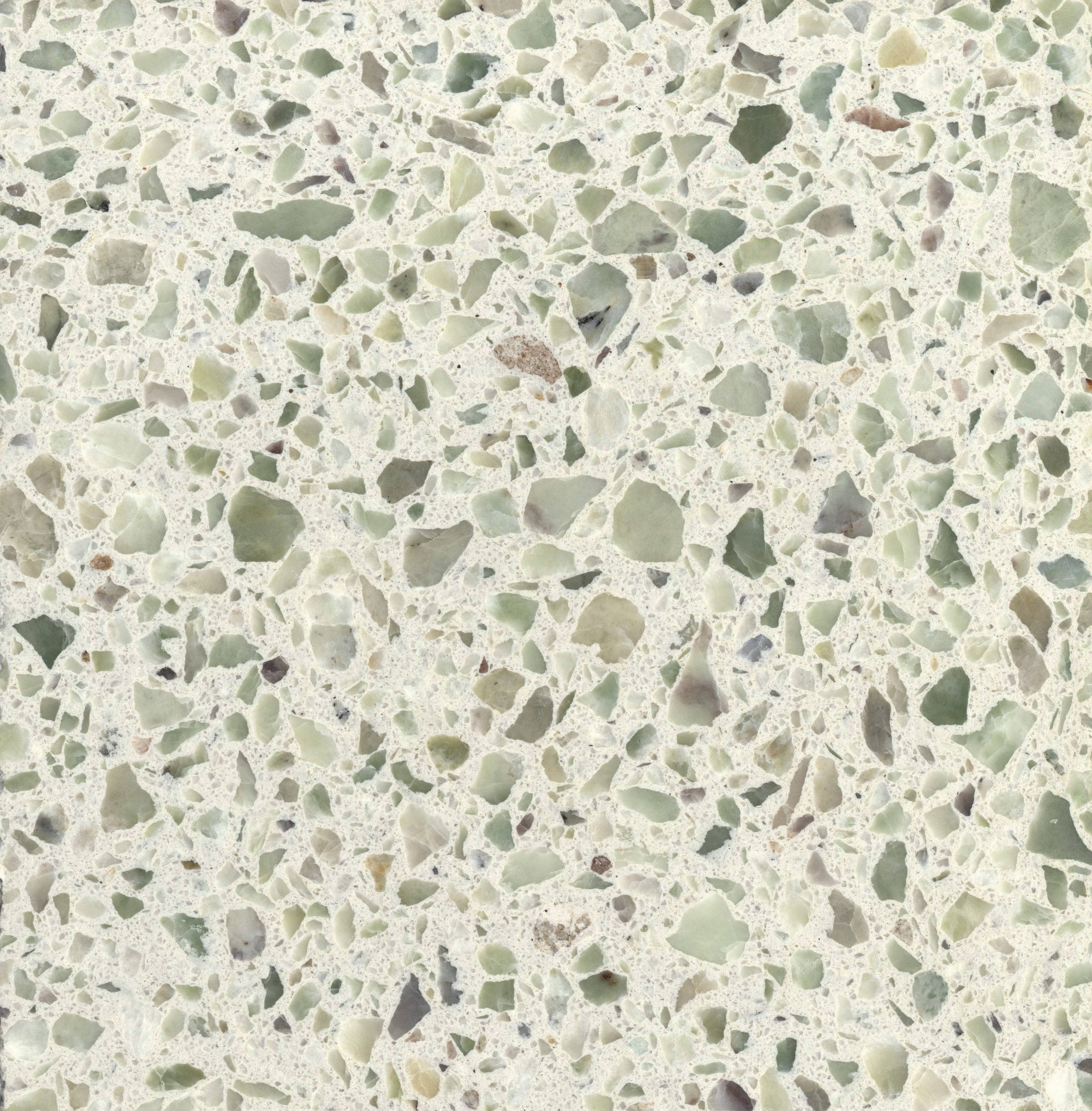 Marble 桌布 壁紙 — 奶油白色黏合劑中嵌入綠色、灰色和米色骨料的斑點水磨石表面的特寫。