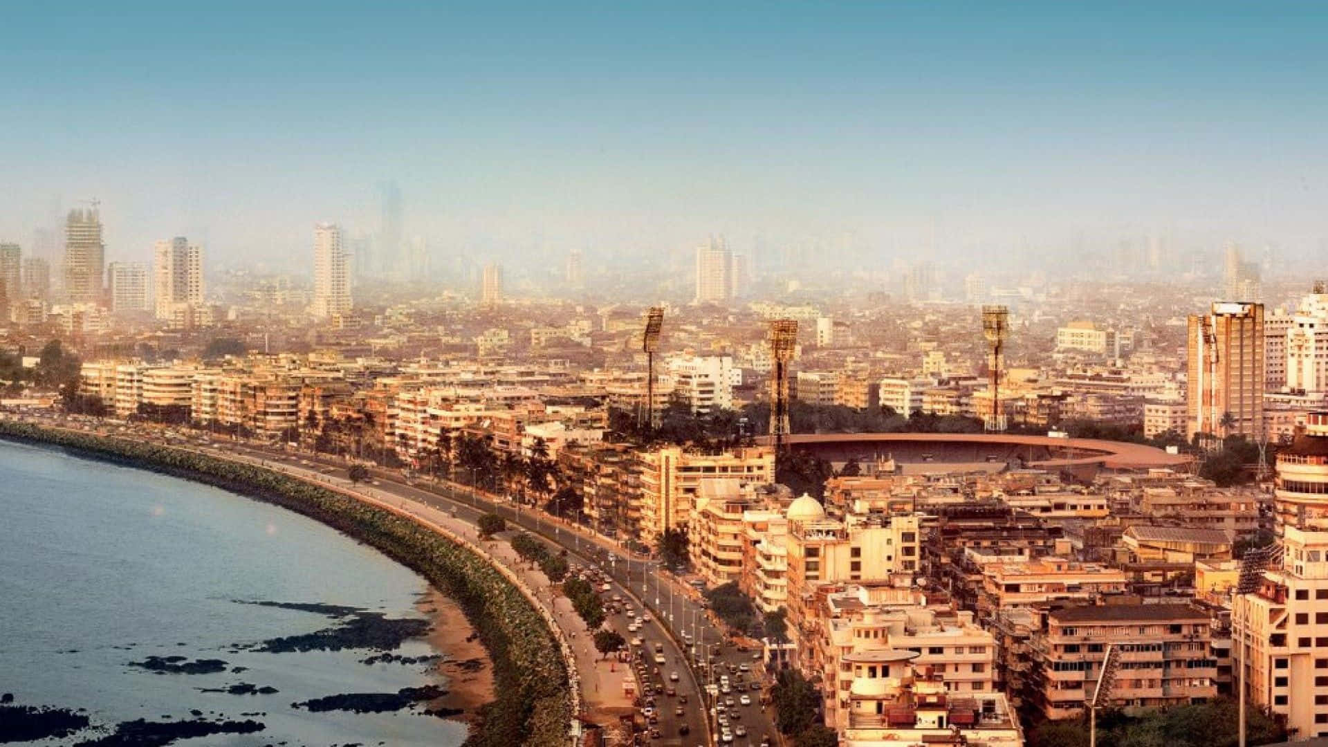 Mumbai 桌布 壁紙 — 孟買海岸城市景觀在黃金時刻的鳥瞰圖，繁忙的道路和標誌性的板球場。