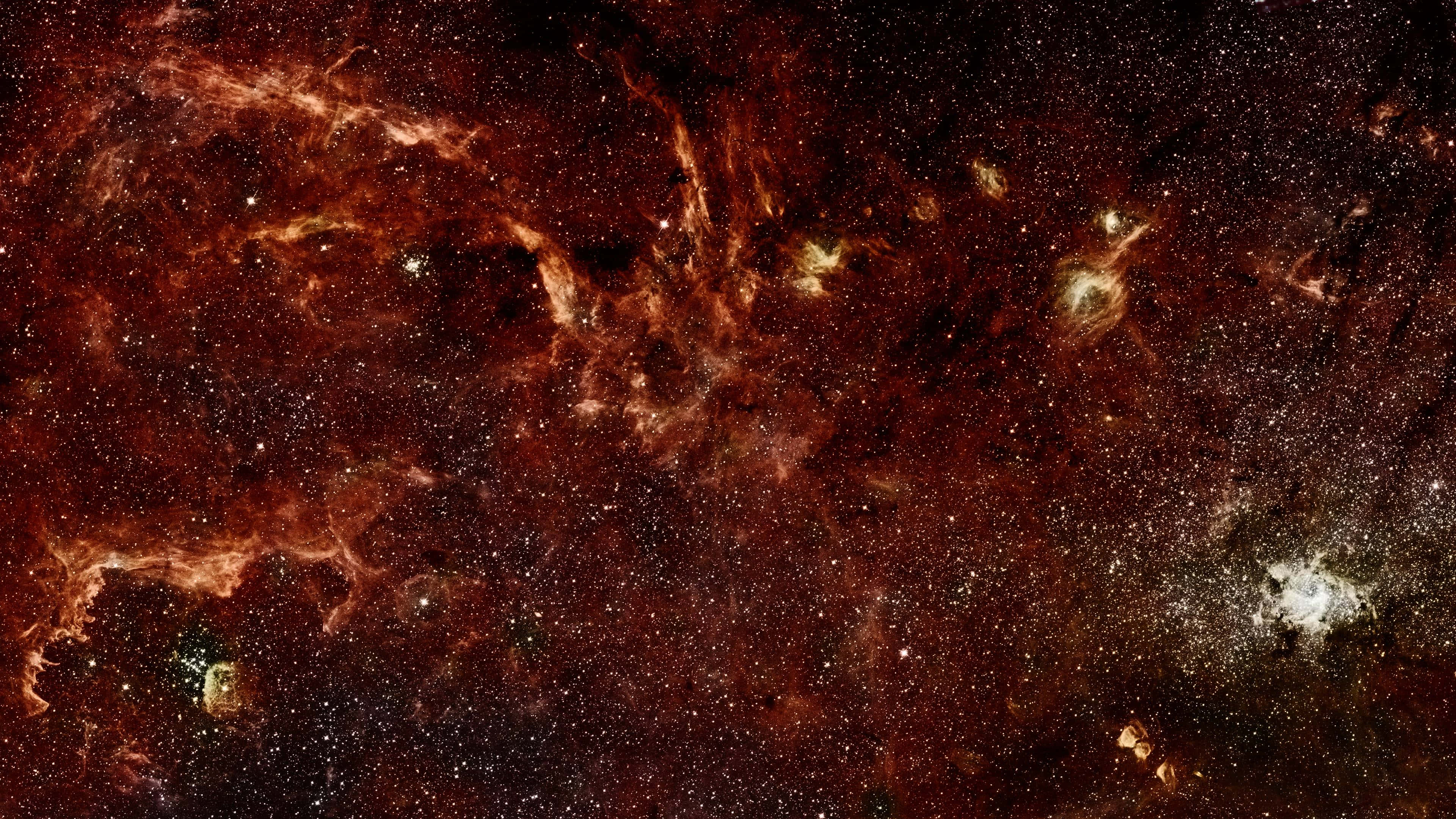桌布 壁紙 — 宇宙星雲以火熱的橙色和深紅色氣體在星空背景下旋轉。