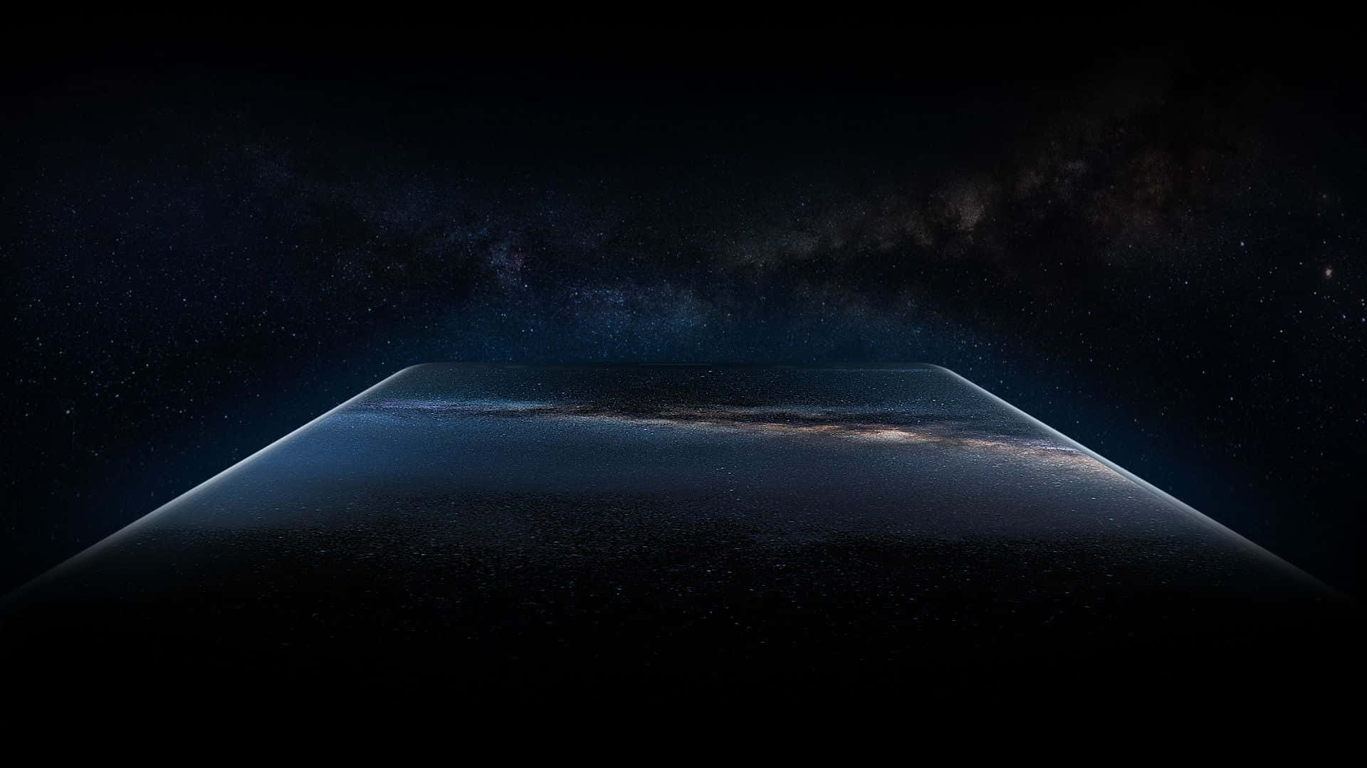 Samsung Dex 桌布 壁紙 — 宇宙景觀展現銀河系在深邃黑色天空下，彎曲在黑暗、佈滿星星的地平線上。