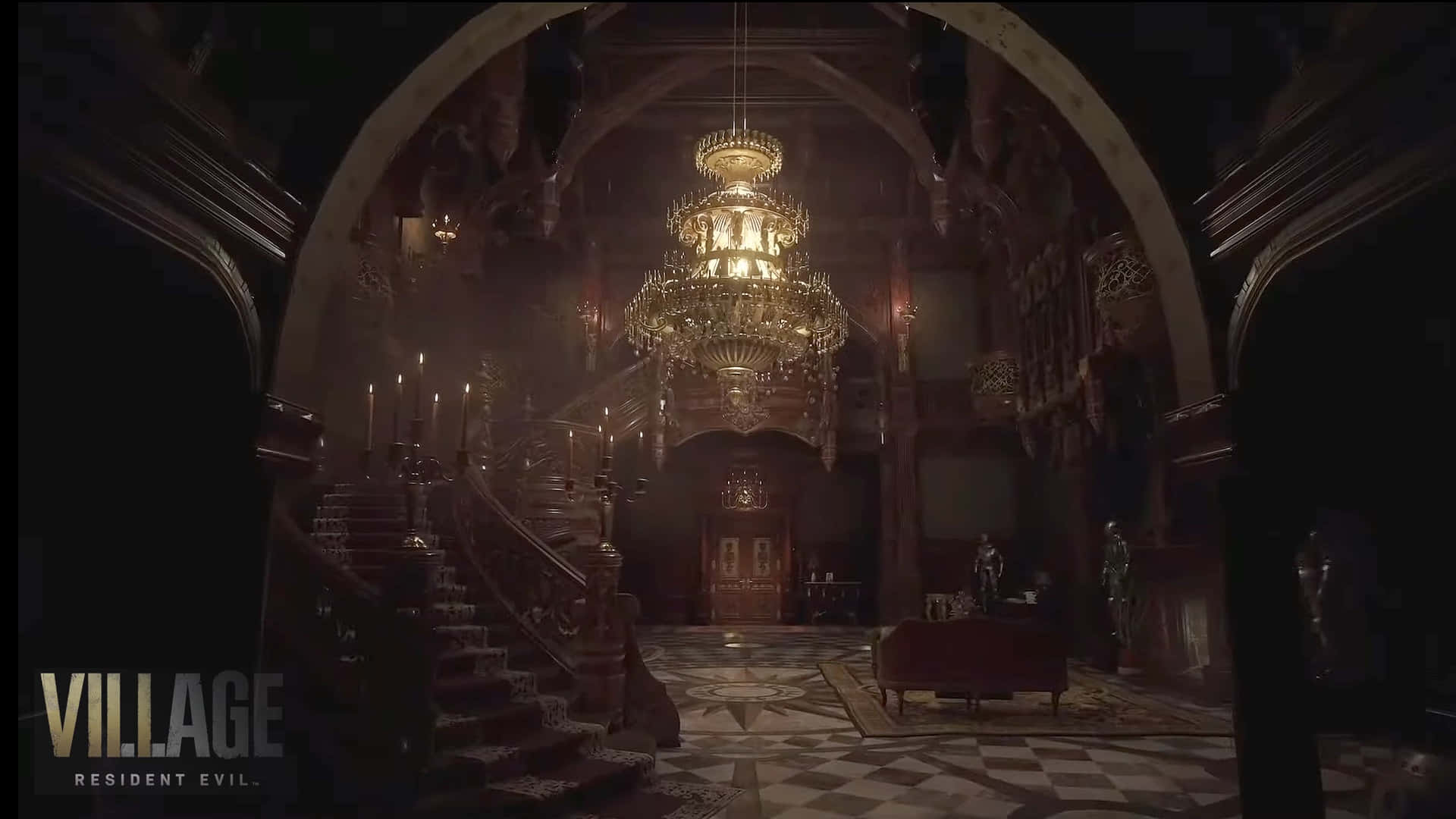 Resident Evil Village 桌布 壁紙 — 宏偉的哥德式大宅走廊，巨大的吊燈將溫暖的光線投射在棋盤格地板和華麗的樓梯上。
