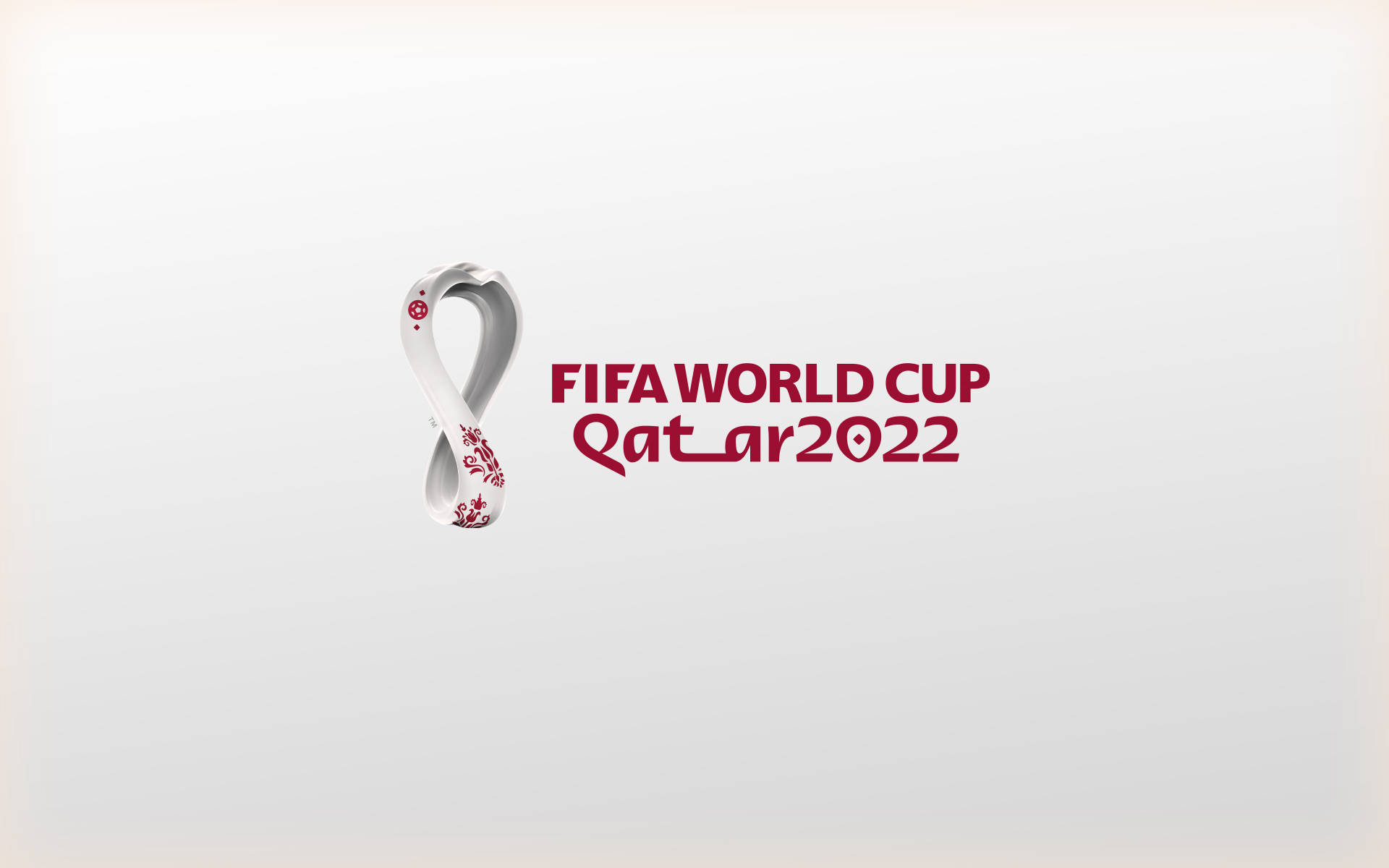 World 桌布 壁紙 — 官方FIFA世界盃卡達2022標誌，以白色無限符號搭配紅色花卉圖案，並在柔和漸層背景上以粗體紅色文字呈現。