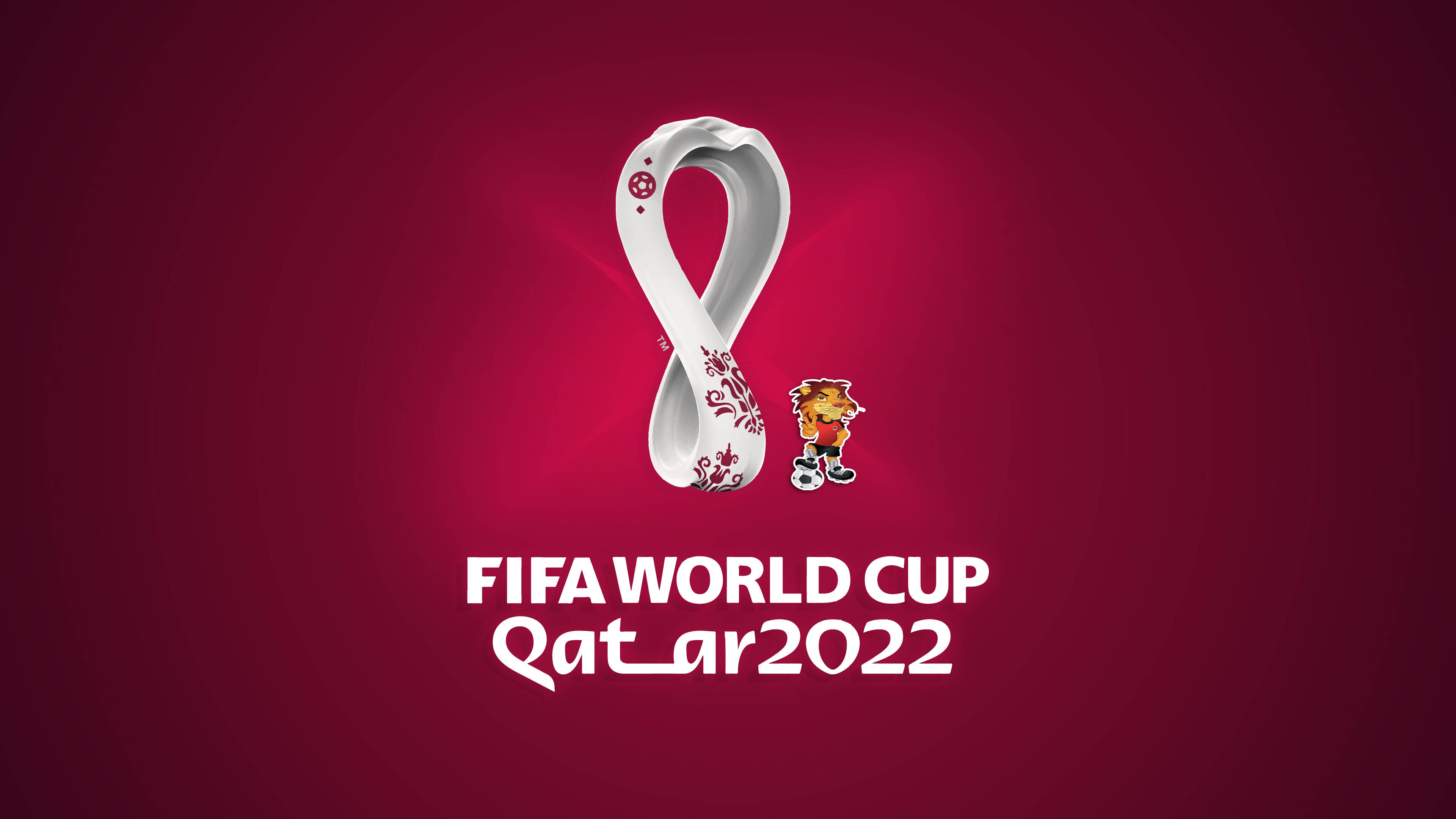 World 桌布 壁紙 — 官方FIFA世界盃卡達2022標誌在深紅色漸變背景上發出白色光芒，旁邊有吉祥物La’eeb。