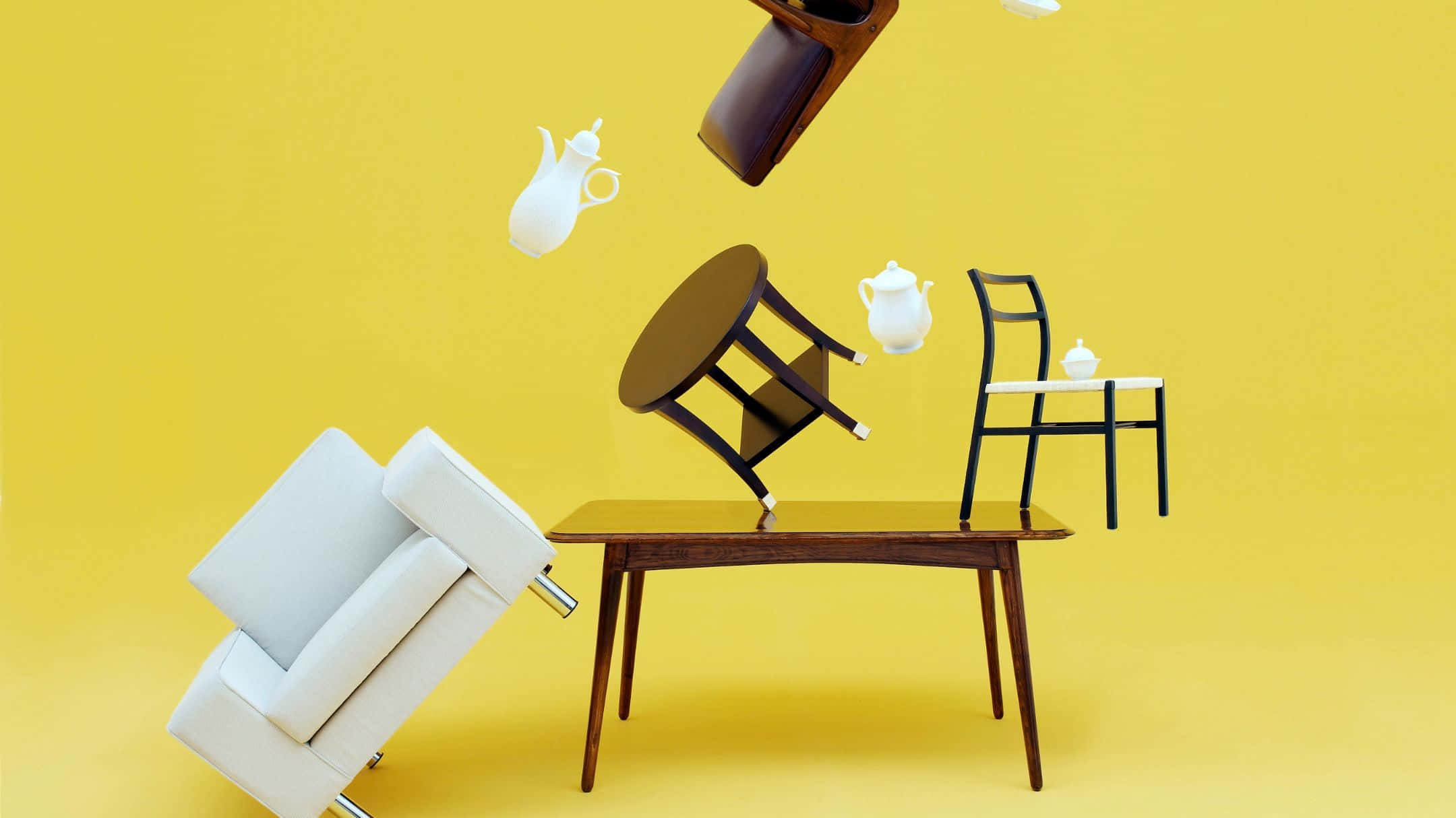 Furniture 桌布 壁紙 — 家具和茶具在鮮黃色背景上動態漂浮，構成超現實靜物畫。