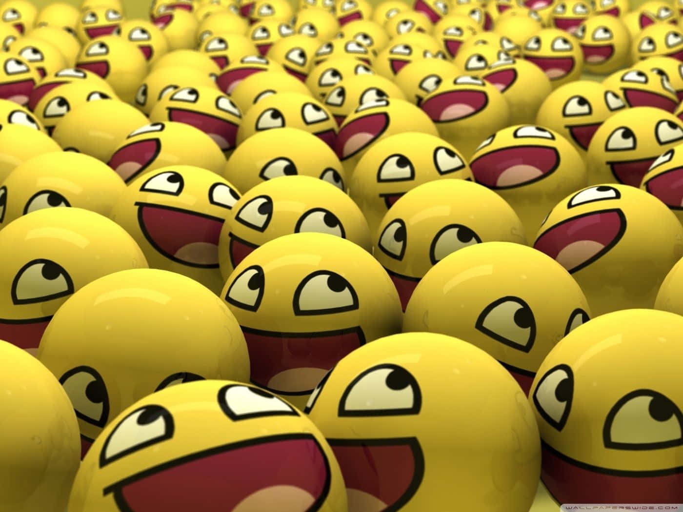 Emoticon 桌布 壁紙 — 密集的光澤黃色表情符號球，咧嘴大笑，眼睛突出。