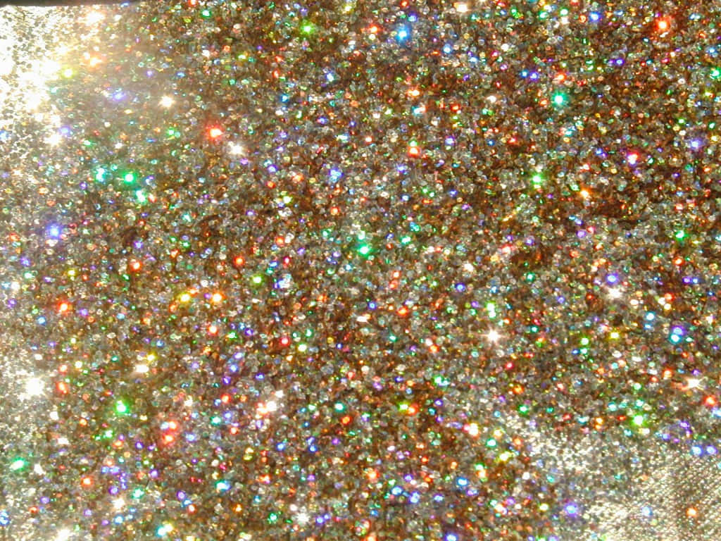 Glittery 桌布 壁紙 — 密集的多色亮粉在明亮光線下閃爍，營造出耀眼閃爍的質感。
