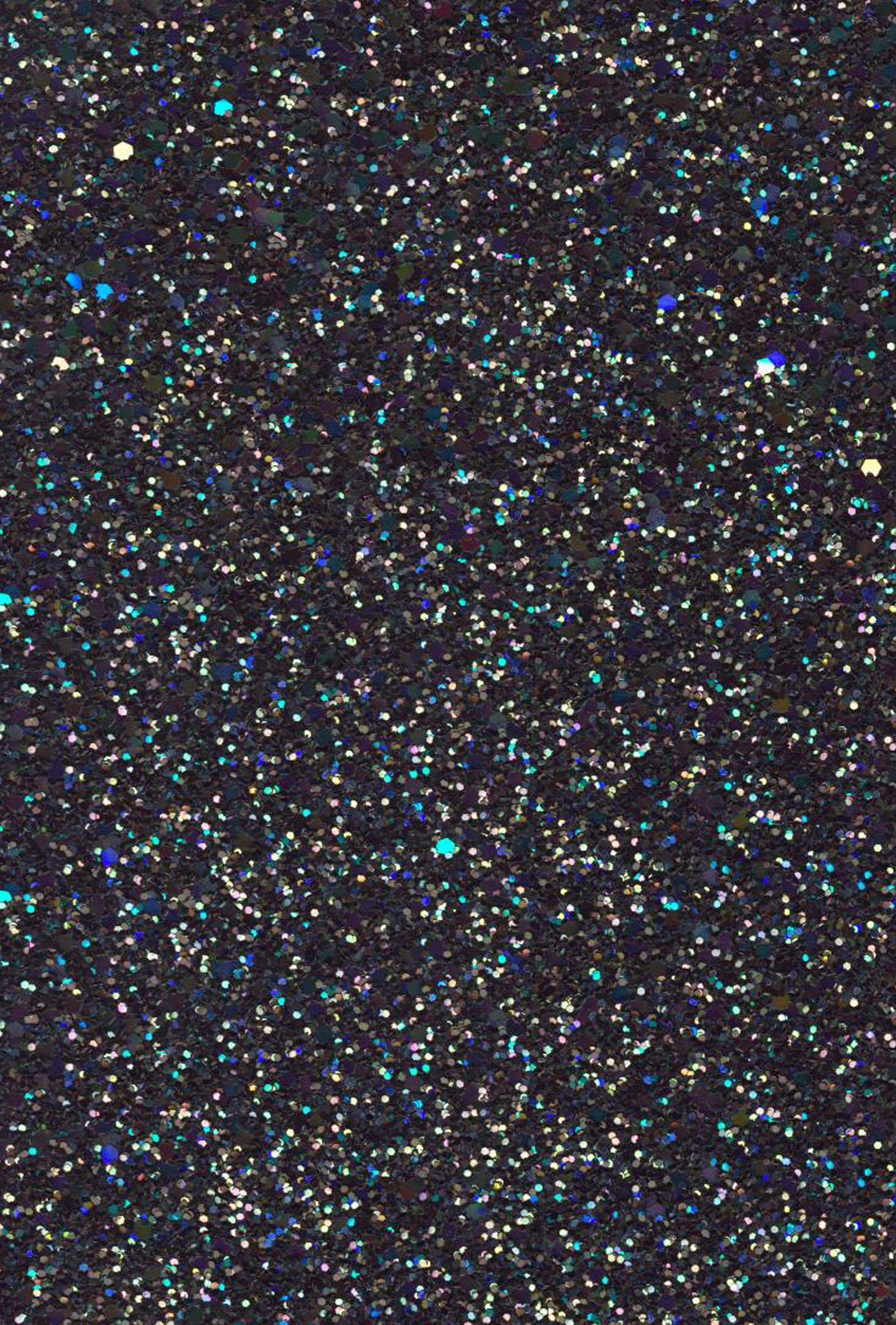 Green Glitter 桌布 壁紙 — 密集的多色閃粉顆粒在深色背景上閃爍，形成閃亮的紋理表面。