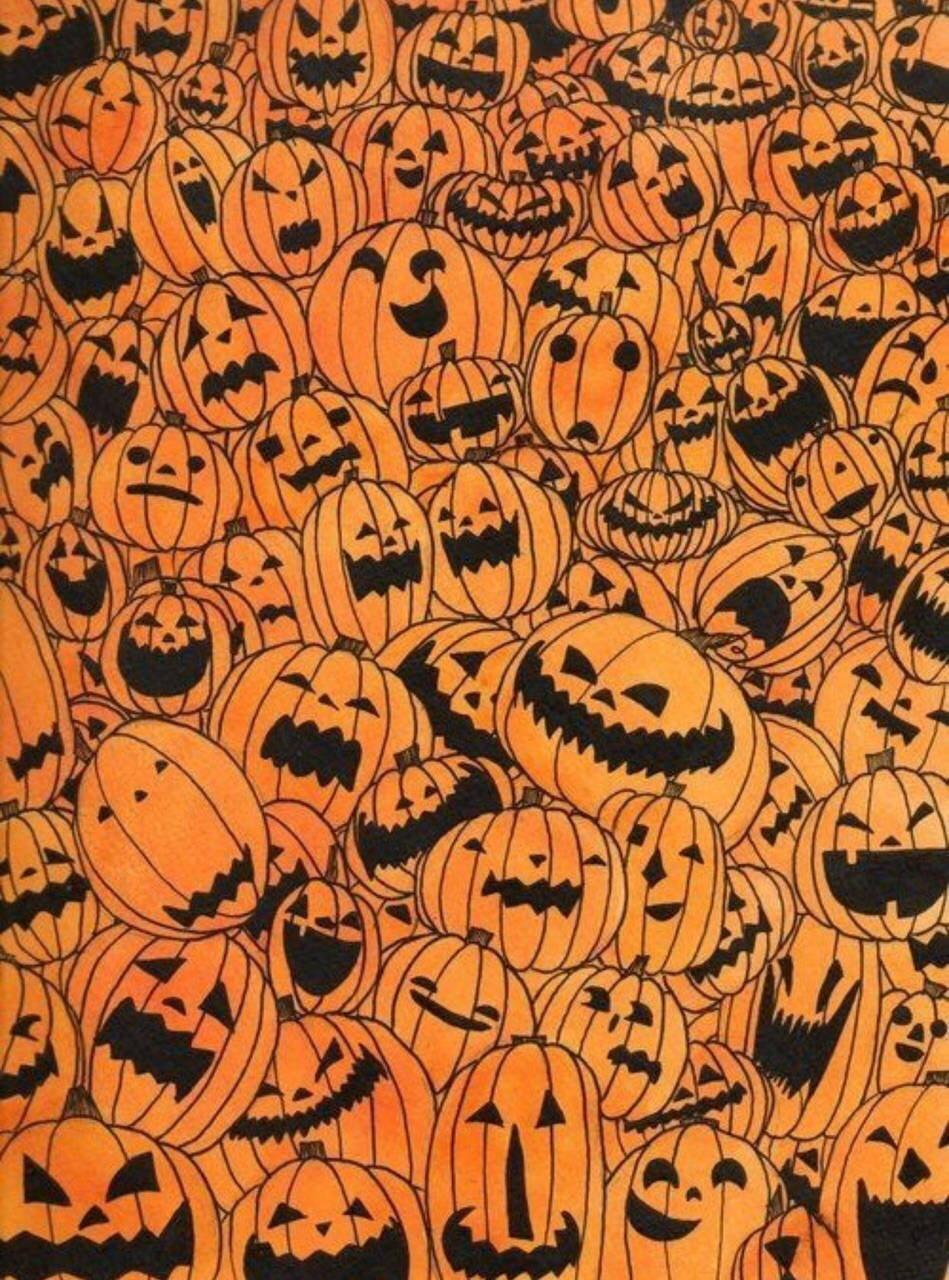 Spooky Season 桌布 壁紙 — 密集的橙色南瓜燈圖案，帶有黑色雕刻面孔，表情各異。