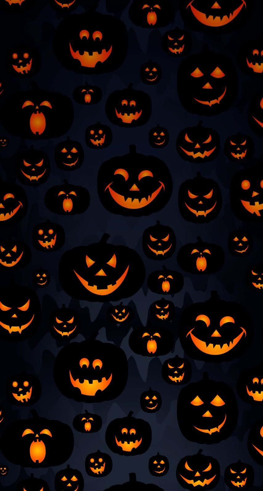 Halloween Laptop 桌布 壁紙 — 密集的發光橙色南瓜燈圖案，有各種笑容和表情，背景是深藍色。