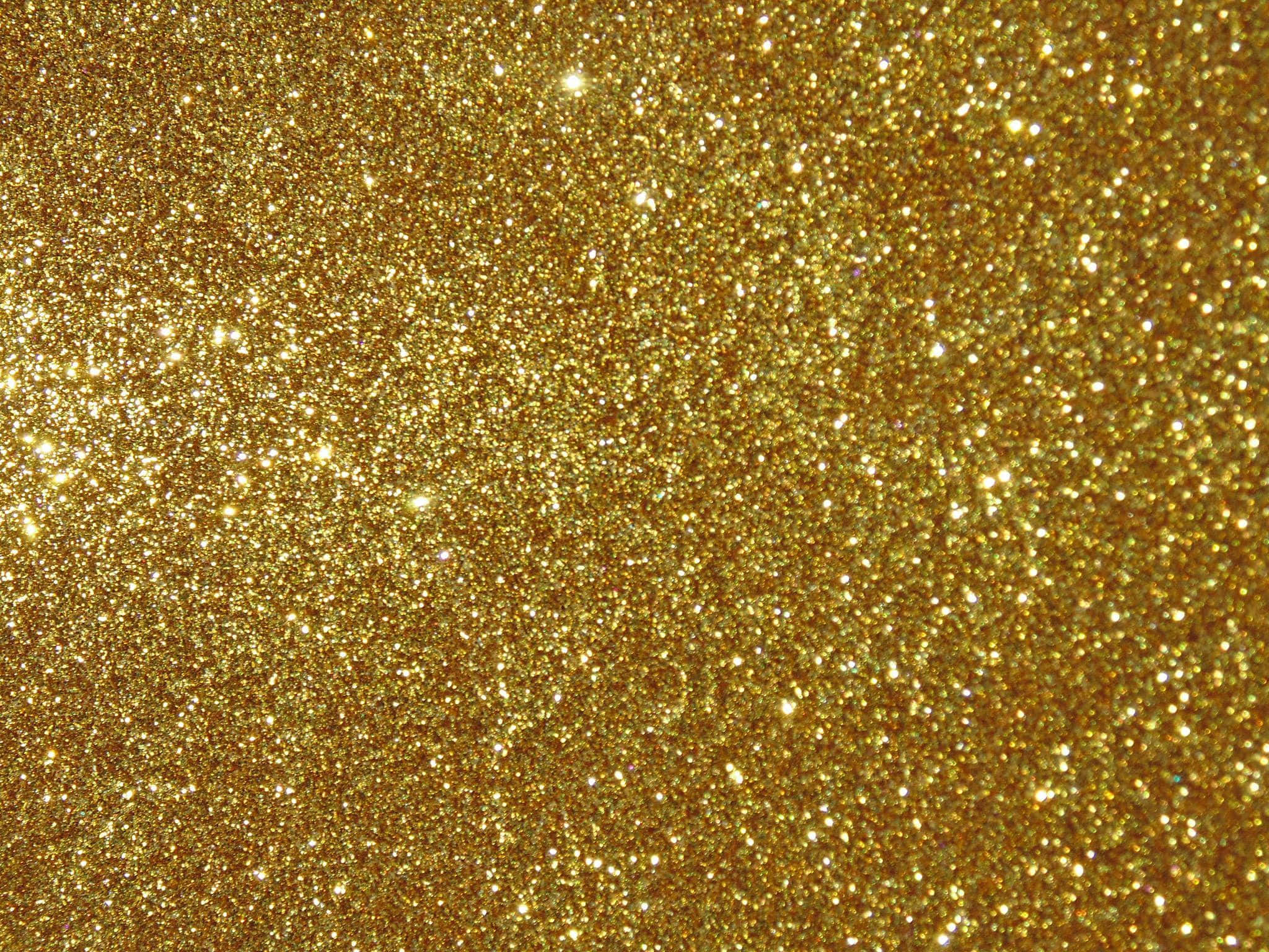 Yellow Glitter 桌布 壁紙 — 密集的金色亮片在明亮光線下閃爍，營造出閃閃發光的紋理表面。
