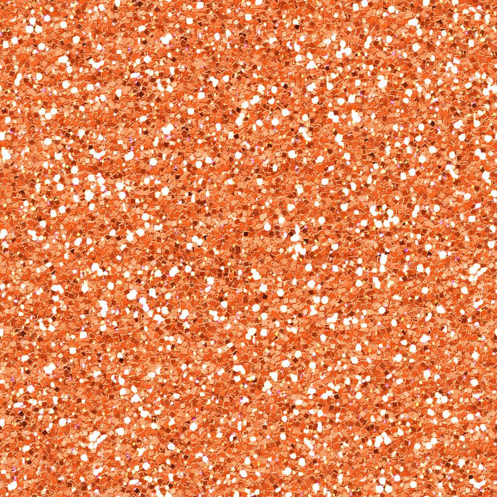 Orange Glitter 桌布 壁紙 — 密集的銅橙色閃粉粒子場，帶有散落的白色斑點，在光線下閃爍。