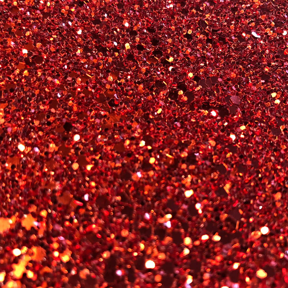 Orange Glitter 桌布 壁紙 — 密集的閃爍紅色亮粉顆粒場，捕捉光線，帶有火熱的橙色亮點。