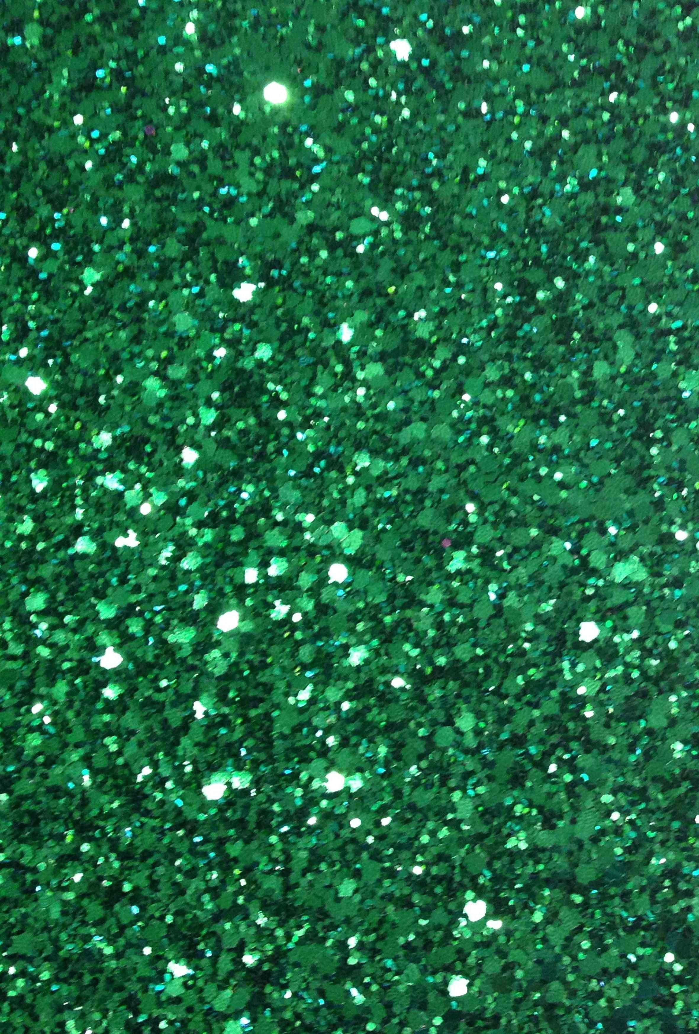 Green Glitter 桌布 壁紙 — 密集的鮮綠色亮粉顆粒，捕捉光線並發出明亮的白色閃光。