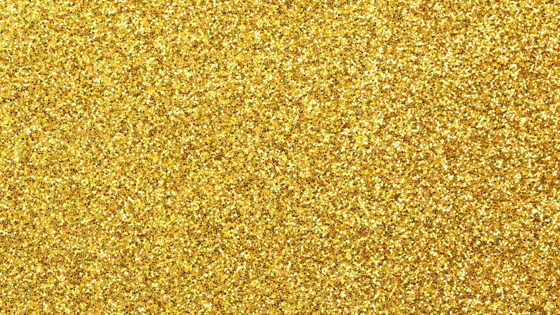Yellow Glitter 桌布 壁紙 — 密集閃爍的金色亮粉粒子形成一個光芒四射的紋理表面。