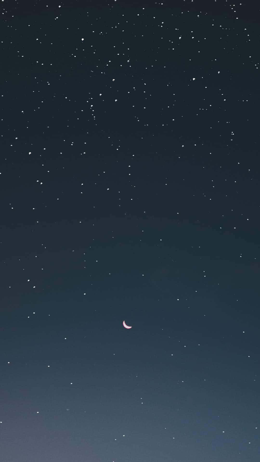 Moon And Stars iPhone 桌布 壁紙 — 寧靜的夜空，充滿無數星星，一輪精緻的粉紅色新月柔和地發光。