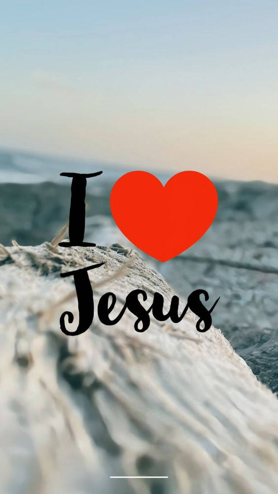 Jesus Quotes 桌布 壁紙 — 寧靜的海灘場景，柔和的波浪和一個大膽的紅色心形，象徵對耶穌的愛，疊加在浮木上。