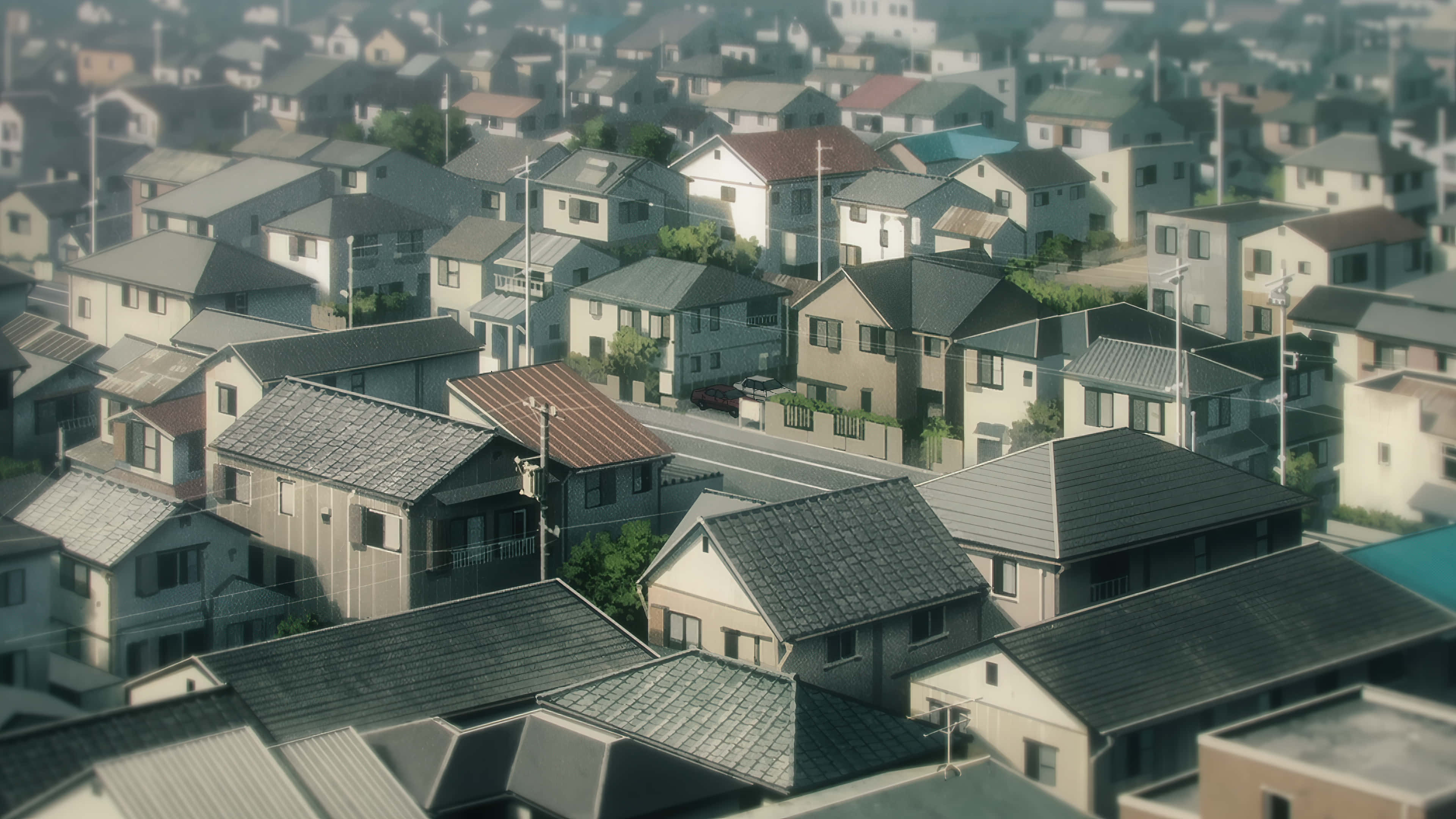 動漫城市 桌布 壁紙 — 寧靜郊區的鳥瞰圖，瓦片屋頂和蜿蜒街道沐浴在柔和日光中。